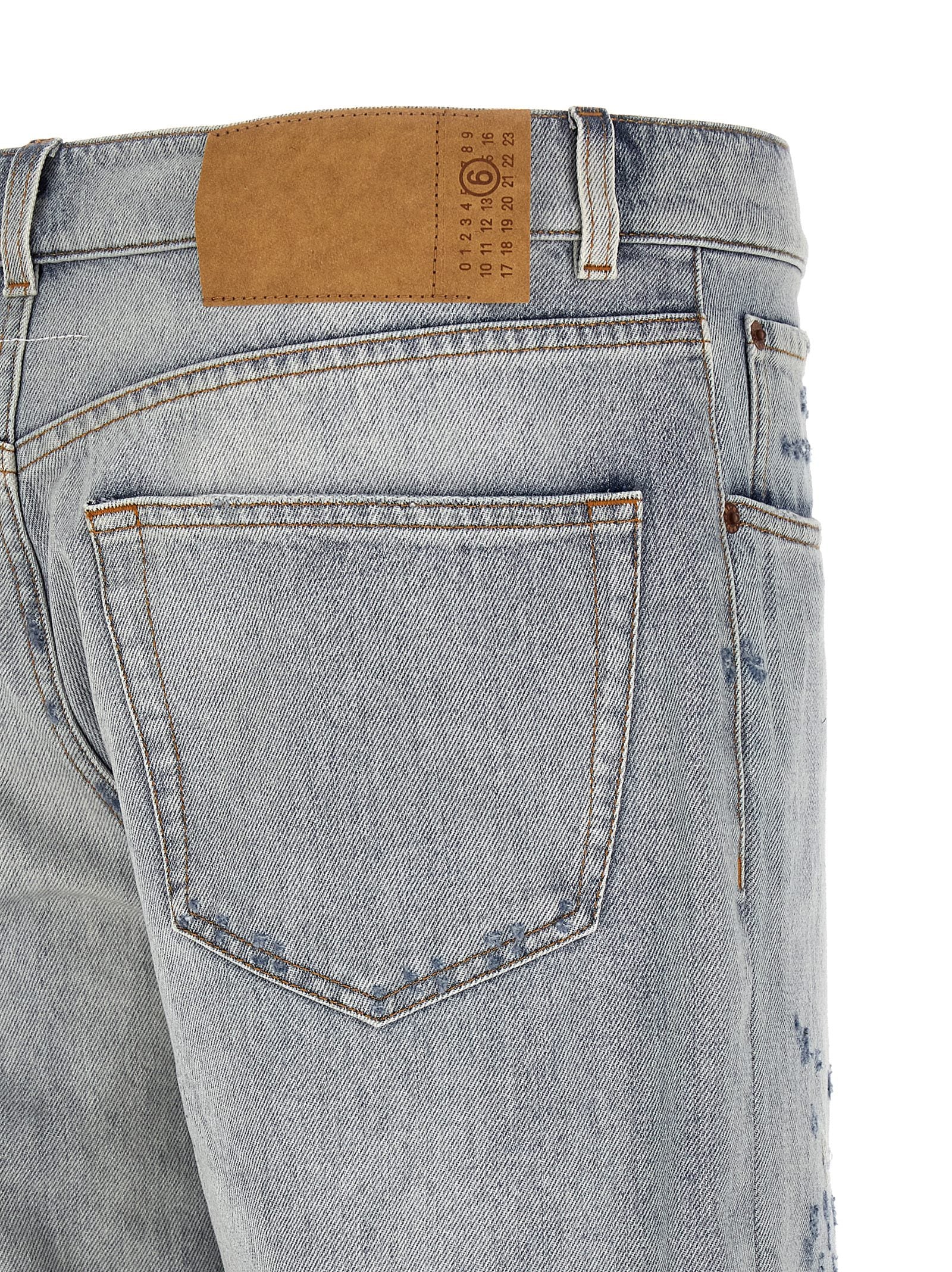 Elevate your style with MM6 Maison Margiela's Blue Cotton Relaxed Fit Jeans, where artisanal Italian craftsmanship meets bold design for a timeless statement.