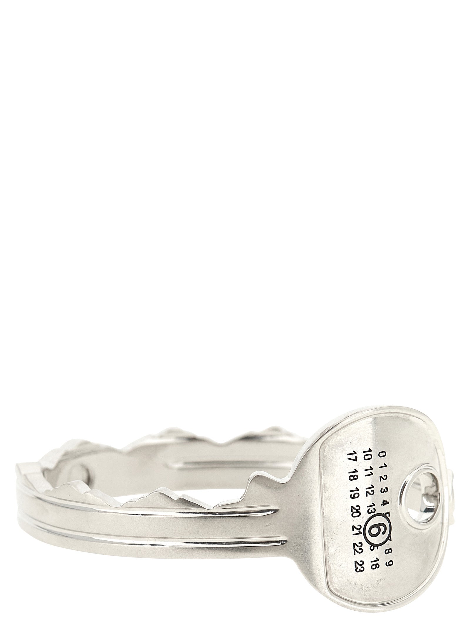 Discover the MM6 Maison Margiela Silver Brass Bracelet, a key-shaped bangle that embodies artisanal elegance and modern sophistication, perfect for the discerning connoisseur.