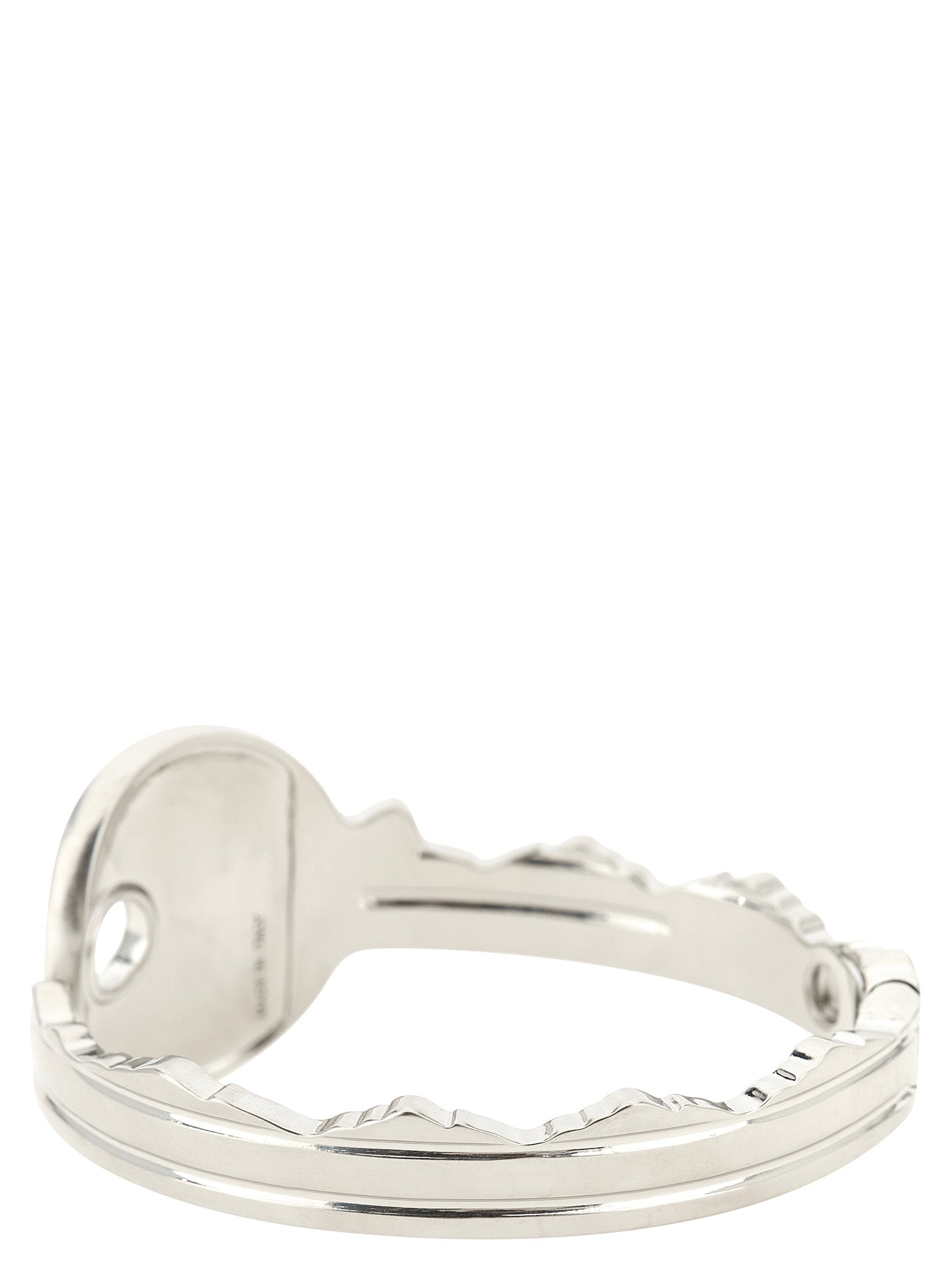 Discover the MM6 Maison Margiela Silver Brass Bracelet, a key-shaped bangle that embodies artisanal elegance and modern sophistication for the discerning individual.