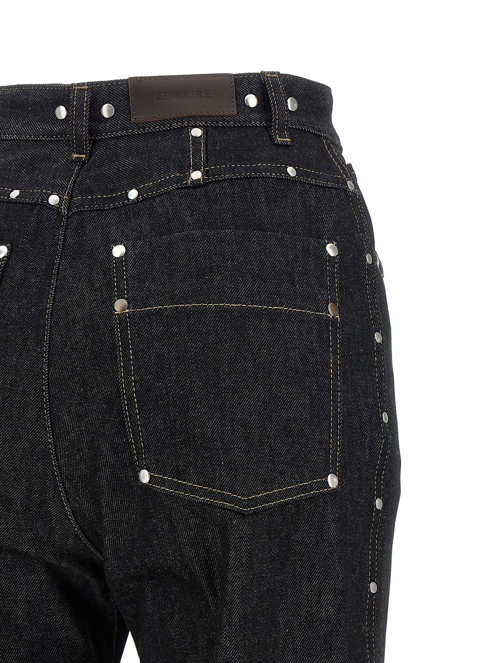 Elevate your style with Lemaire's Black Cotton High-Waisted Jean, crafted in Italy from luxurious cotton, embodying timeless elegance and sophisticated allure.
