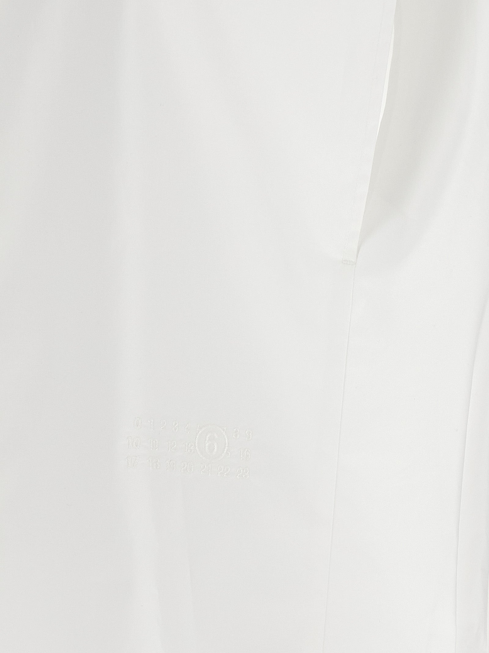 Discover the MM6 Maison Margiela White Cotton Blouse, a masterpiece of minimalist elegance and avant-garde sophistication, perfect for the discerning individual.