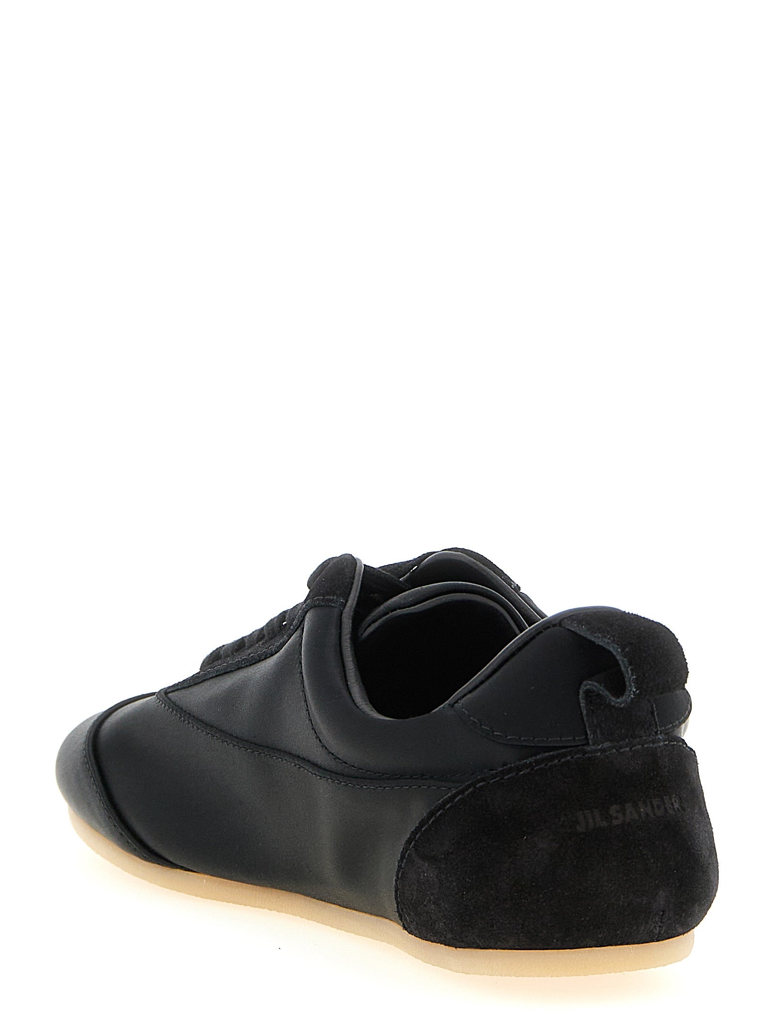 Experience the allure of Jil Sander's Black Cotton Low Top Sneakers, where artisanal craftsmanship meets luxurious materials, perfect for the discerning fashion connoisseur.