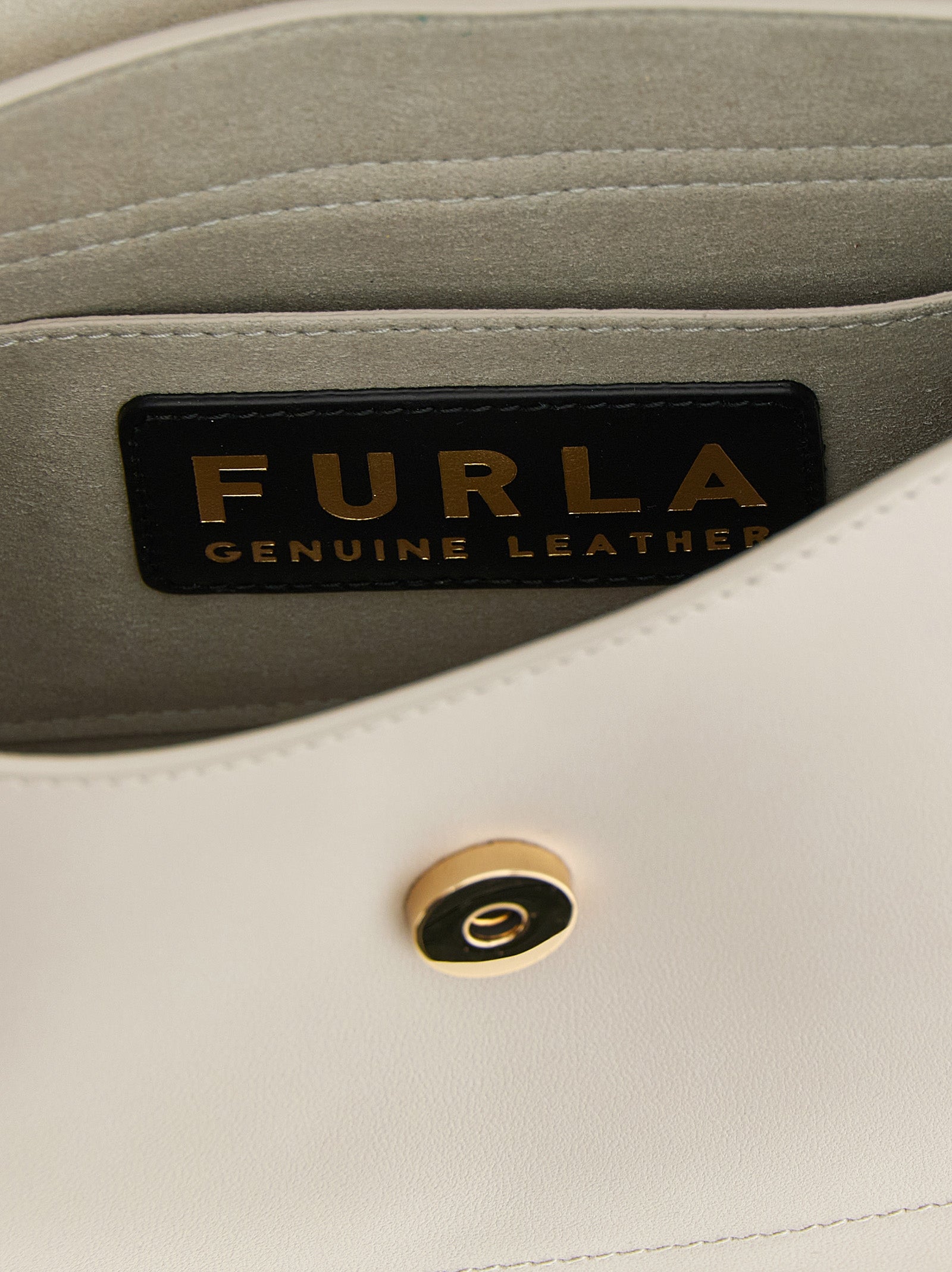 Indulge in the exquisite Furla Beige Calfskin Shoulder Bag, a timeless accessory crafted from luxurious calfskin, embodying elegance and sophistication for every occasion.