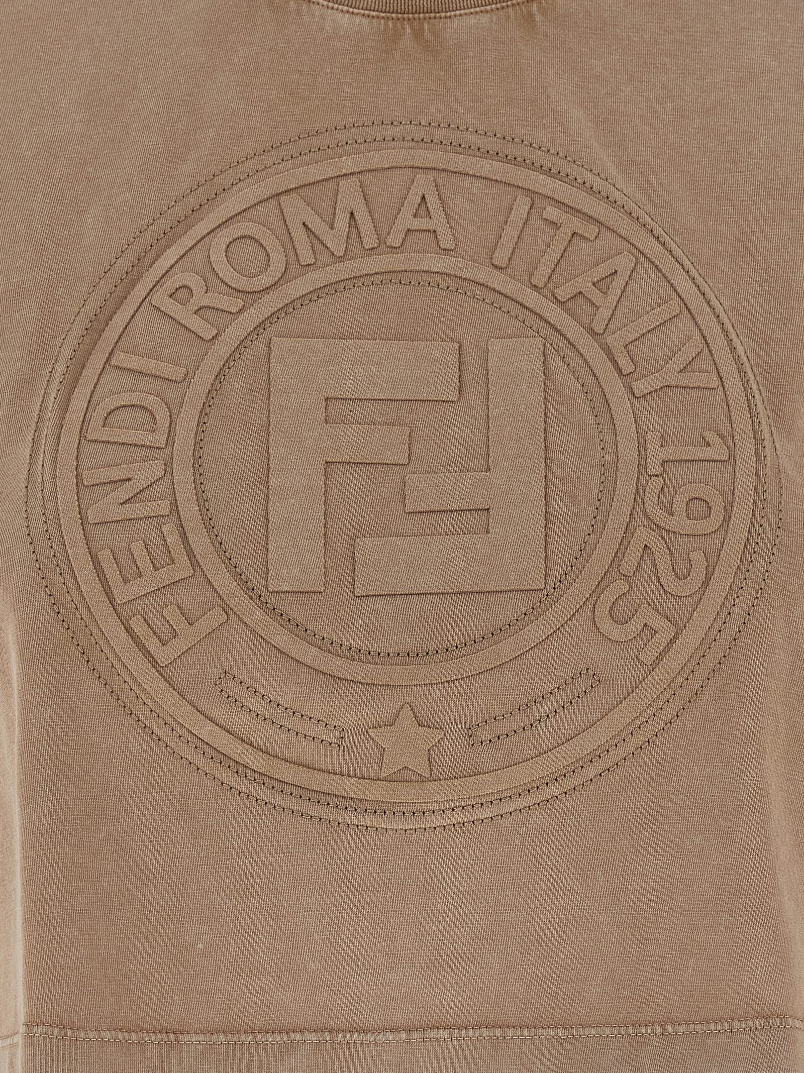 Indulge in the Fendi Brown Cotton T-Shirt, a luxurious blend of Italian craftsmanship and modern elegance, perfect for those who appreciate timeless sophistication.