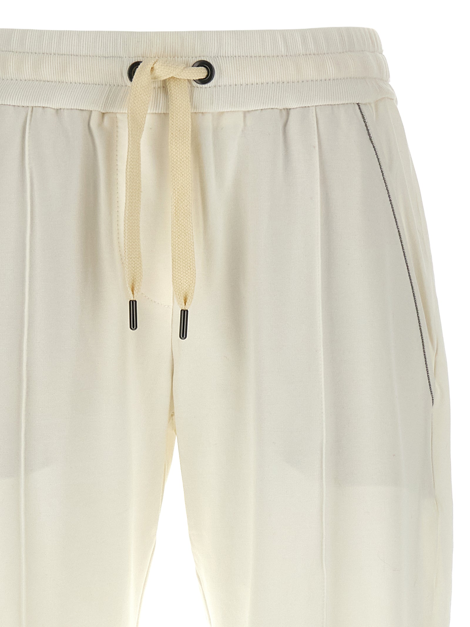 Experience unparalleled elegance with Brunello Cucinelli White Cotton Joggers, crafted from luxurious brushed cotton for a refined, sophisticated silhouette.