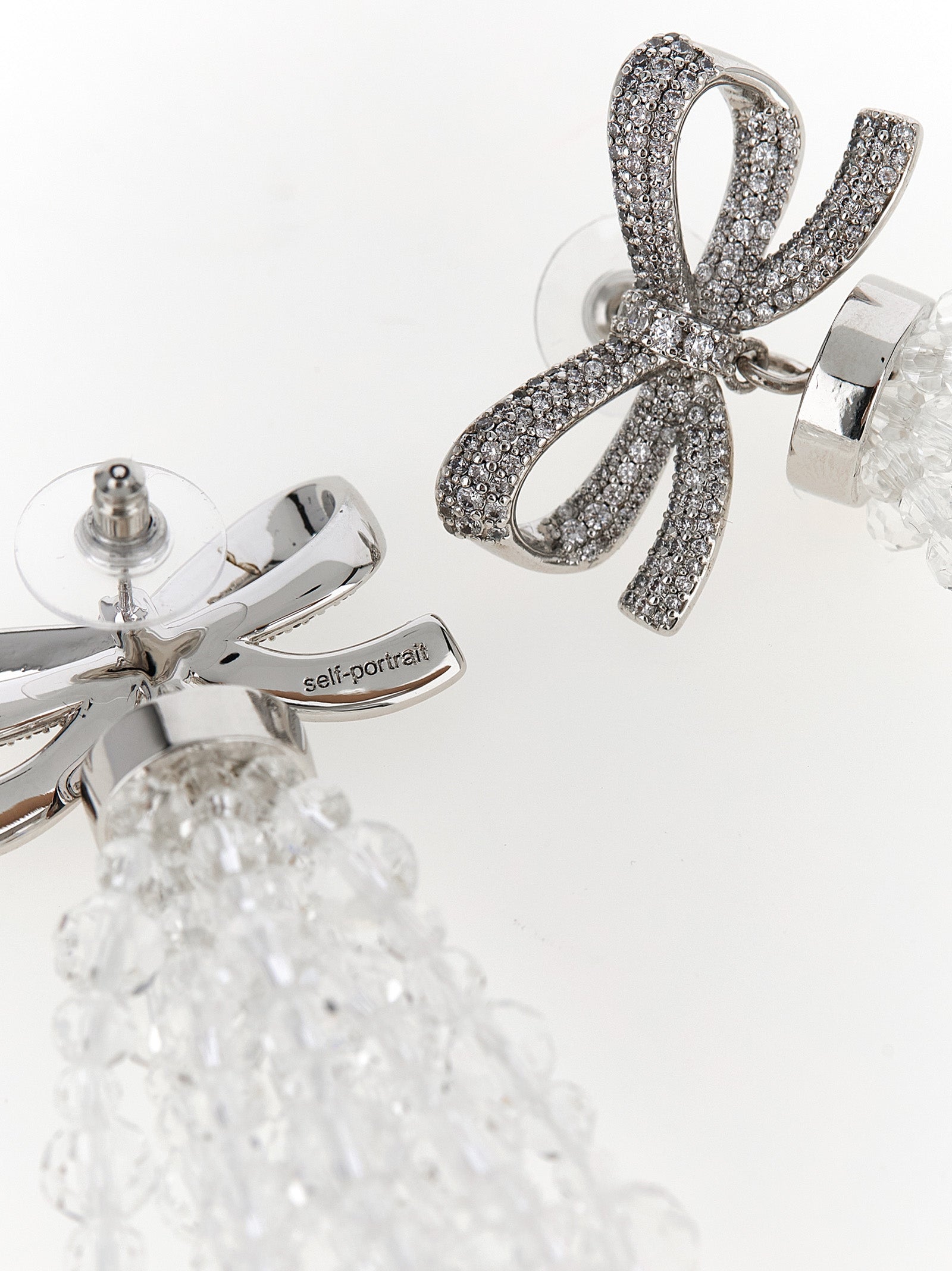 Discover the Self-Portrait Silver Copper Bow Beaded Waterfall Earrings, a stunning blend of exquisite craftsmanship and bold design, perfect for unforgettable moments.