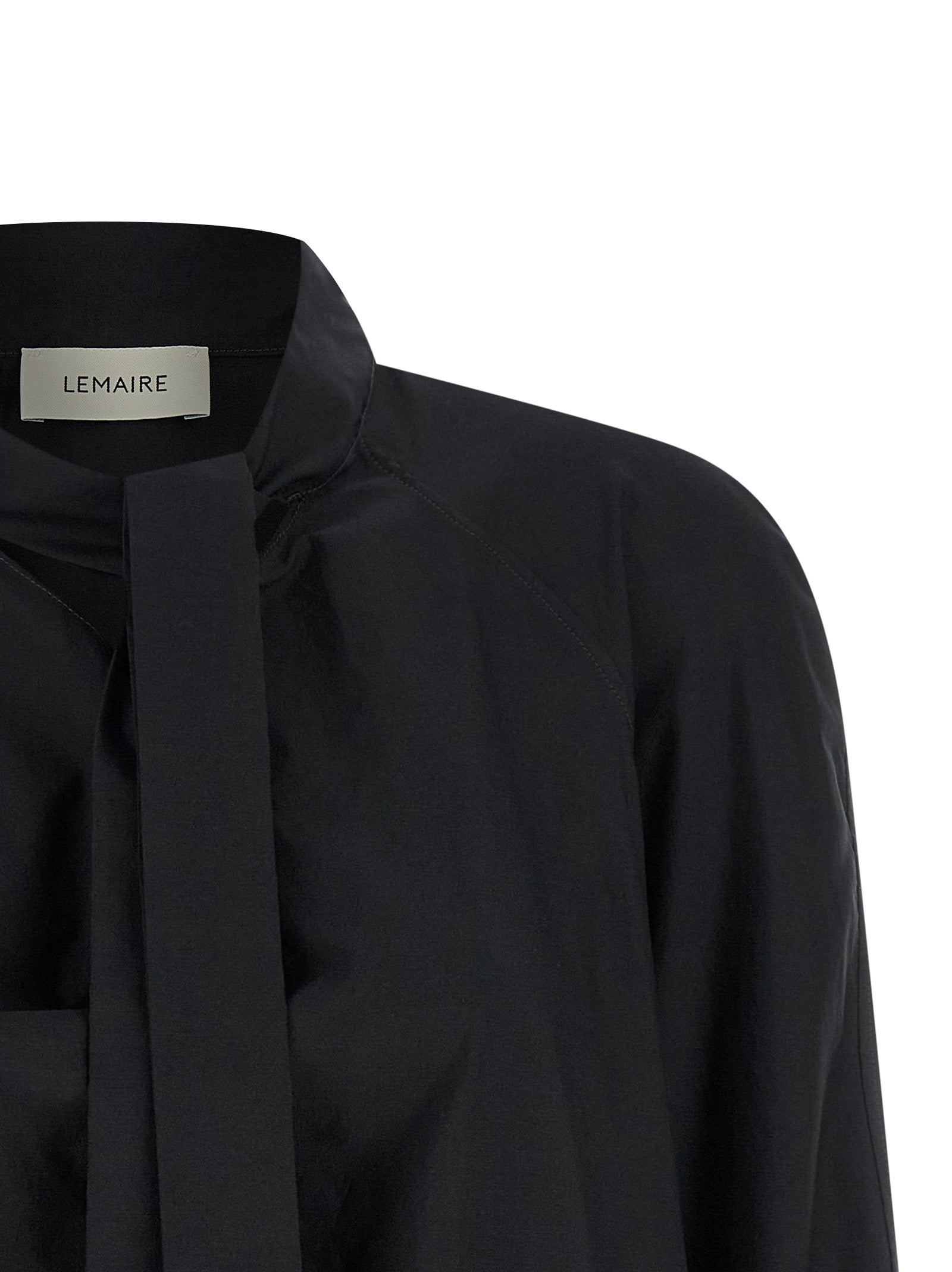 Elevate your wardrobe with the Lemaire Ascot Blouse, a luxurious blend of cotton and silk, embodying sophistication and timeless elegance for any occasion.
