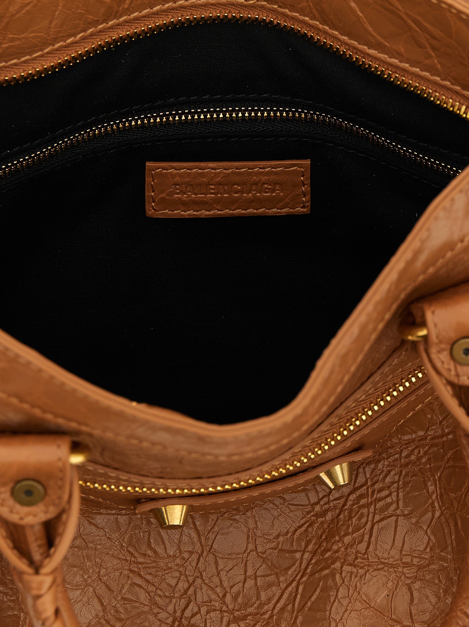 Indulge in the exquisite allure of the Balenciaga Brown Lamb Leather Handbag, a masterpiece of Italian craftsmanship that elevates your style with luxurious sophistication.