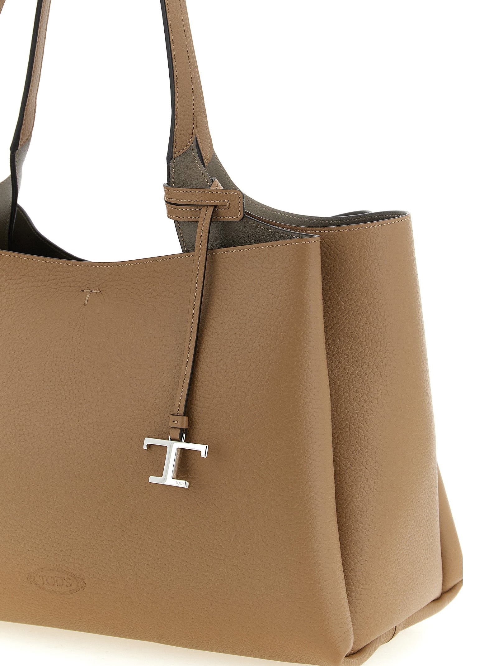 Experience the exquisite Tod's Brown Calfskin Tote Bag, a masterclass in Italian craftsmanship, merging luxury and functionality for the discerning individual.