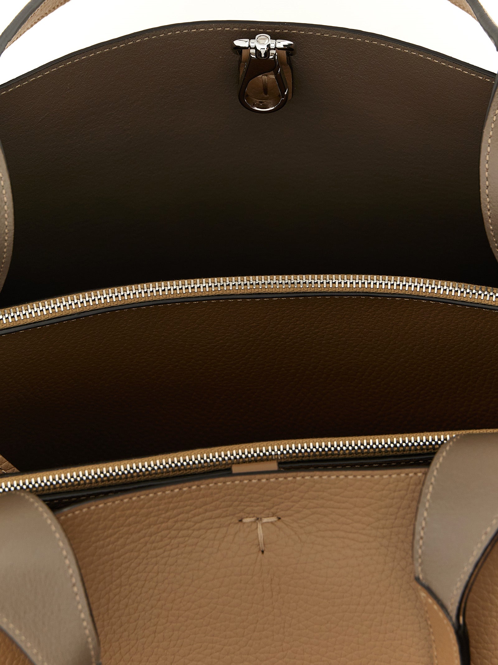 Experience the timeless elegance of Tod's Brown Calfskin Tote Bag, a masterpiece of Italian craftsmanship, blending luxurious leather with sophisticated design for the discerning individual.