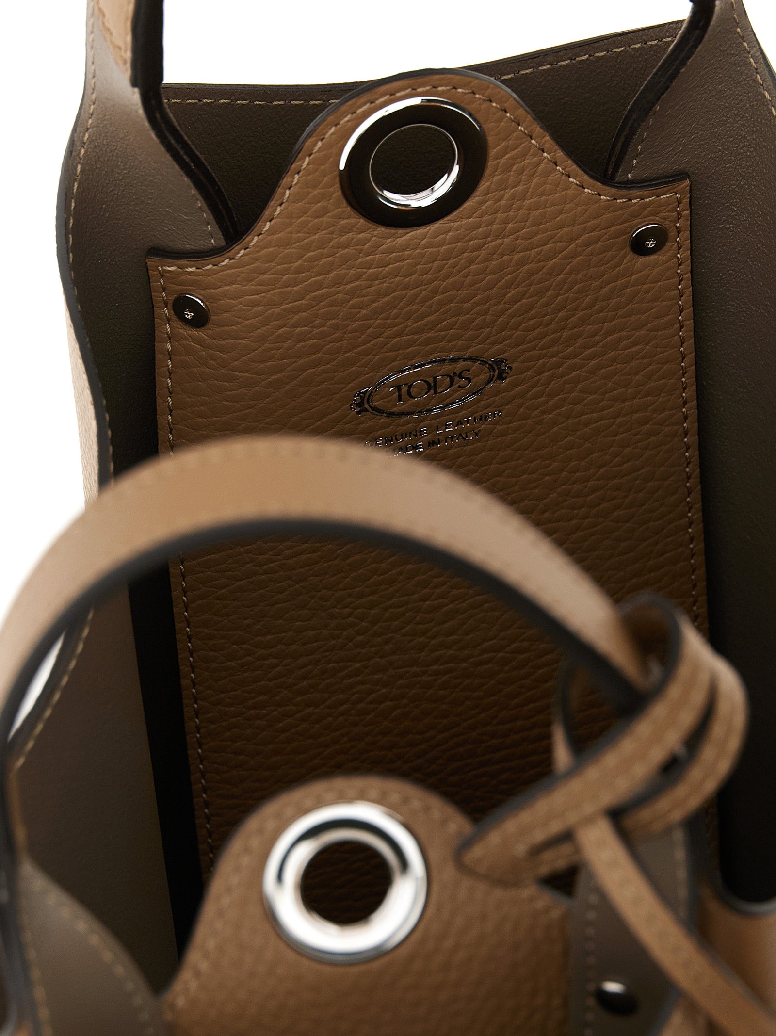 Discover the Tod's Brown Calfskin Handbag, a masterpiece of Italian craftsmanship that embodies timeless luxury and sophistication for the discerning individual.