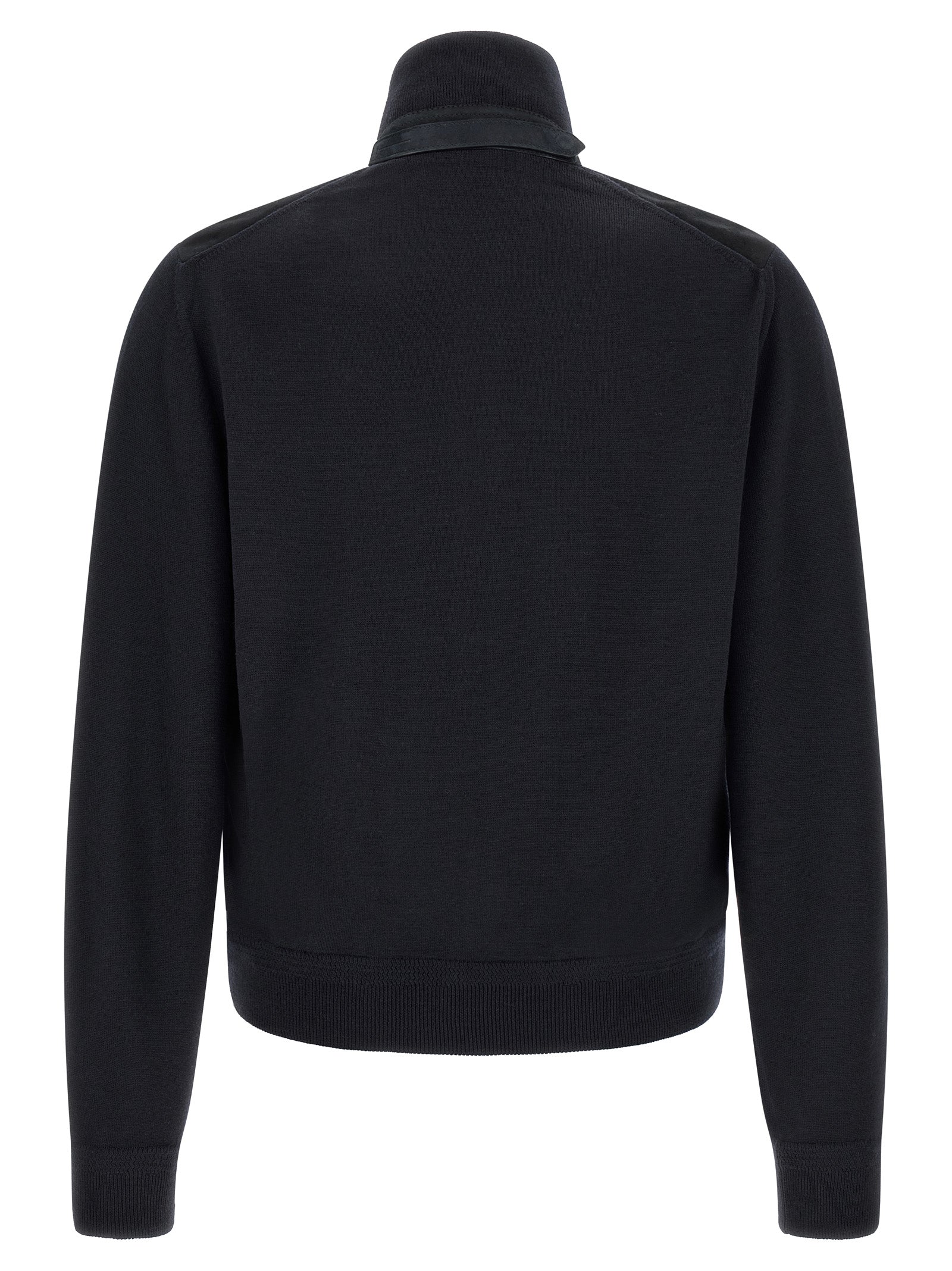 Experience the exquisite allure of the Tom Ford Blue Wool Cardigan, where luxurious suede meets soft merino wool, embodying timeless elegance and sophisticated craftsmanship.