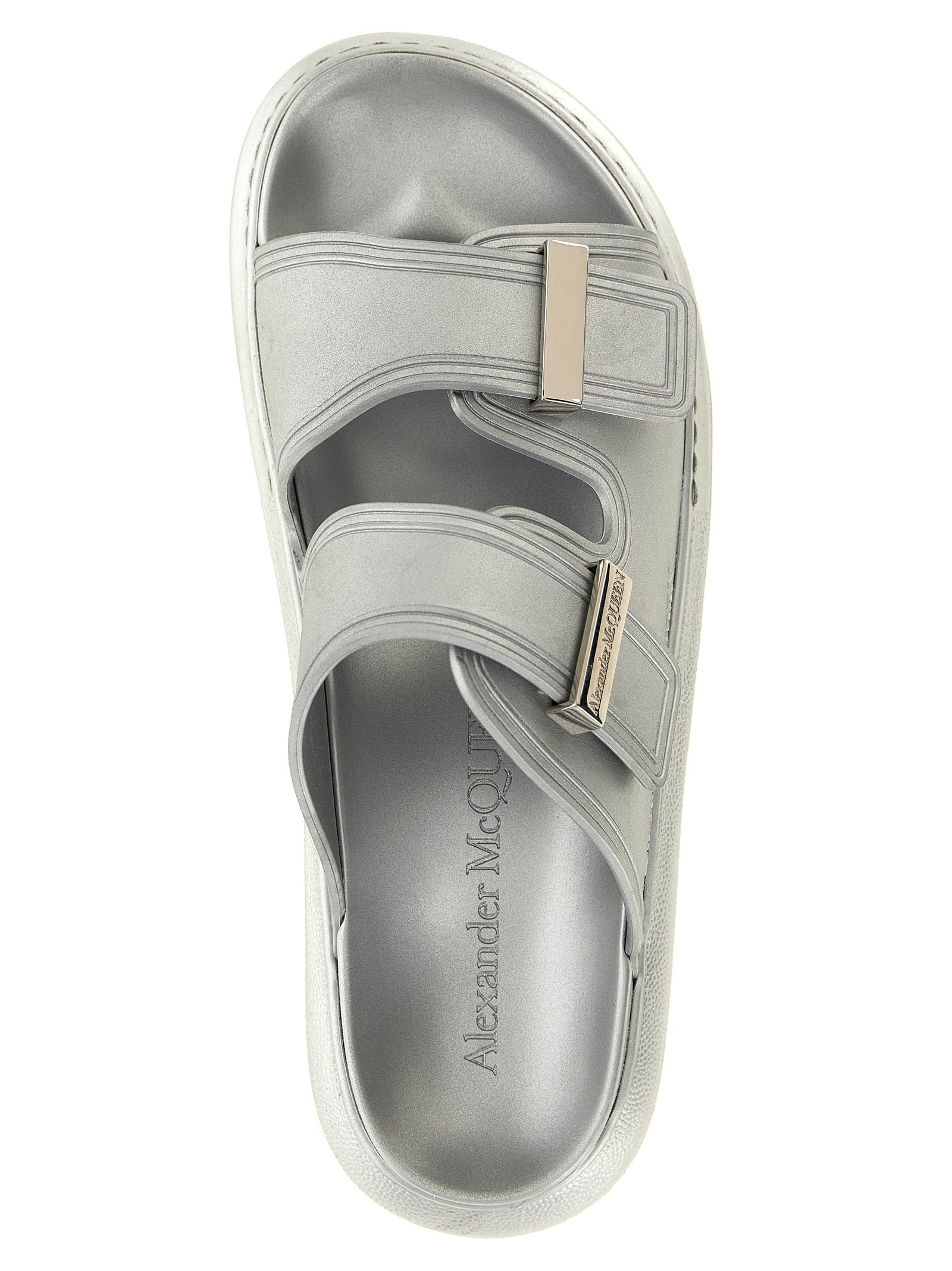 Indulge in the opulence of Alexander McQueen Silver Rubber Slides, where avant-garde design meets luxurious comfort, perfect for the discerning connoisseur.