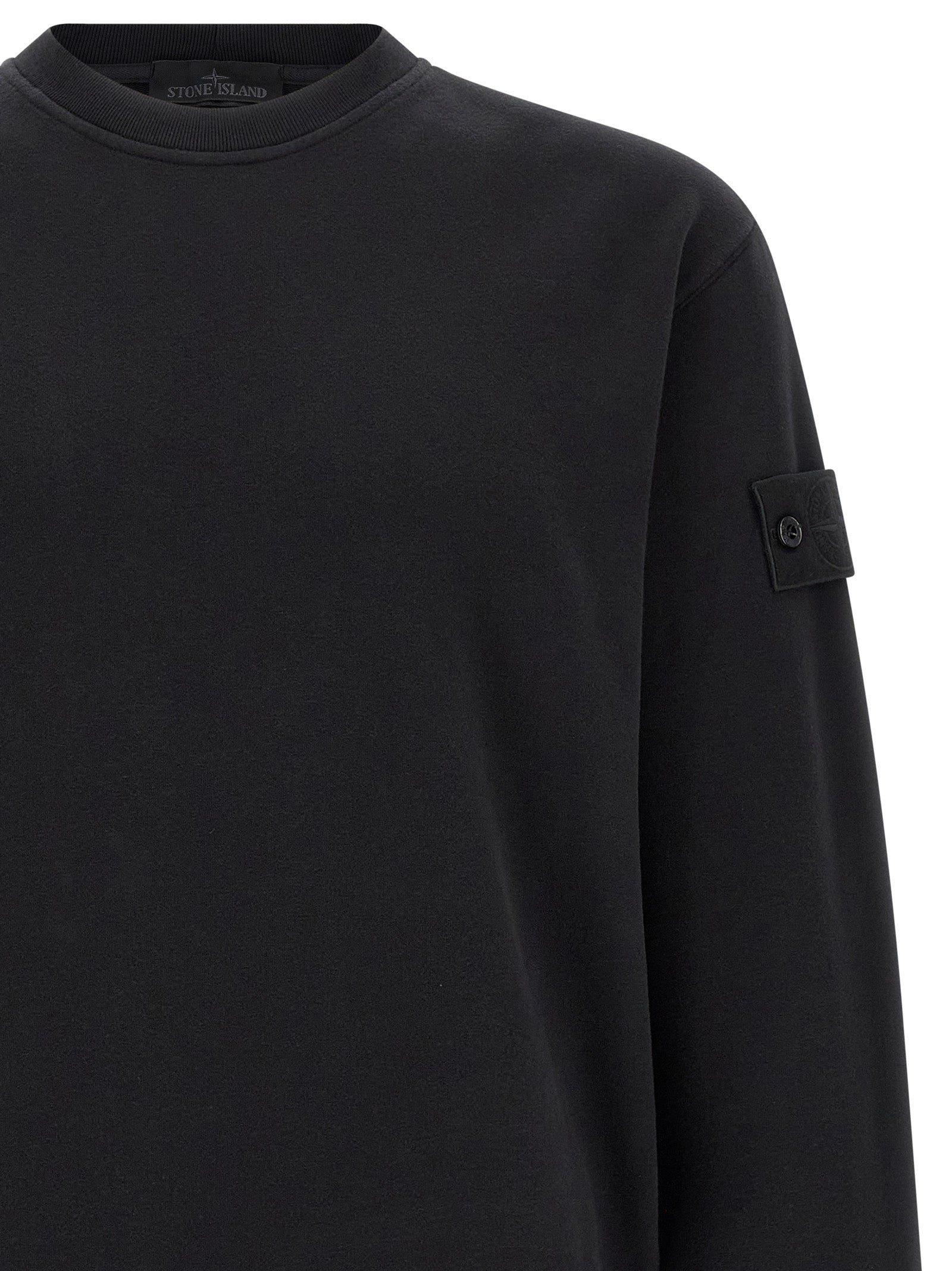 Indulge in the Stone Island Black Cotton Sweatshirt, a luxurious blend of sustainable organic cotton and refined design, perfect for the discerning individual seeking elegance and comfort.