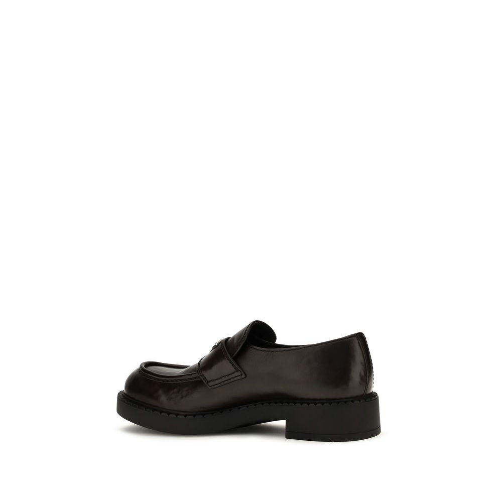 Experience the allure of Prada's Brown Calf Leather Bos Taurus Slip-On Loafers, where exquisite craftsmanship meets timeless elegance, perfect for the discerning individual.