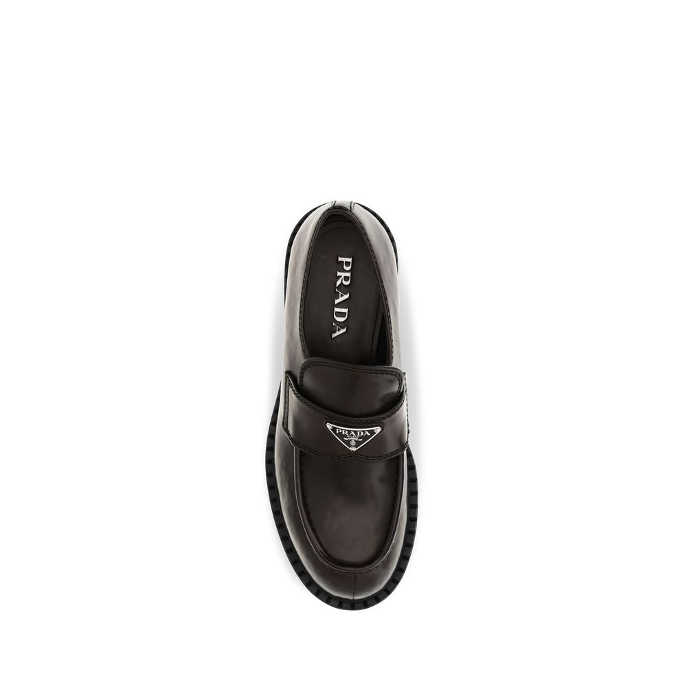 Experience the allure of Prada's Brown Calf Leather Bos Taurus Slip-On Loafers, where exquisite craftsmanship meets timeless elegance, perfect for the discerning connoisseur.