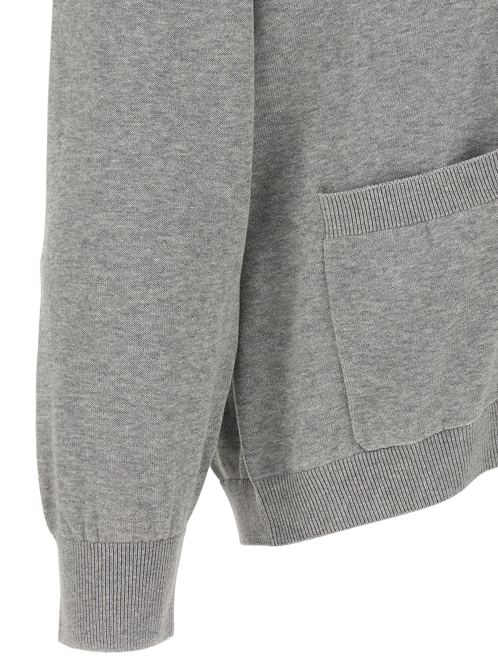 Indulge in the timeless elegance of the Brunello Cucinelli Gray Cotton Cardigan, crafted from luxurious cotton for unparalleled comfort and sophistication.