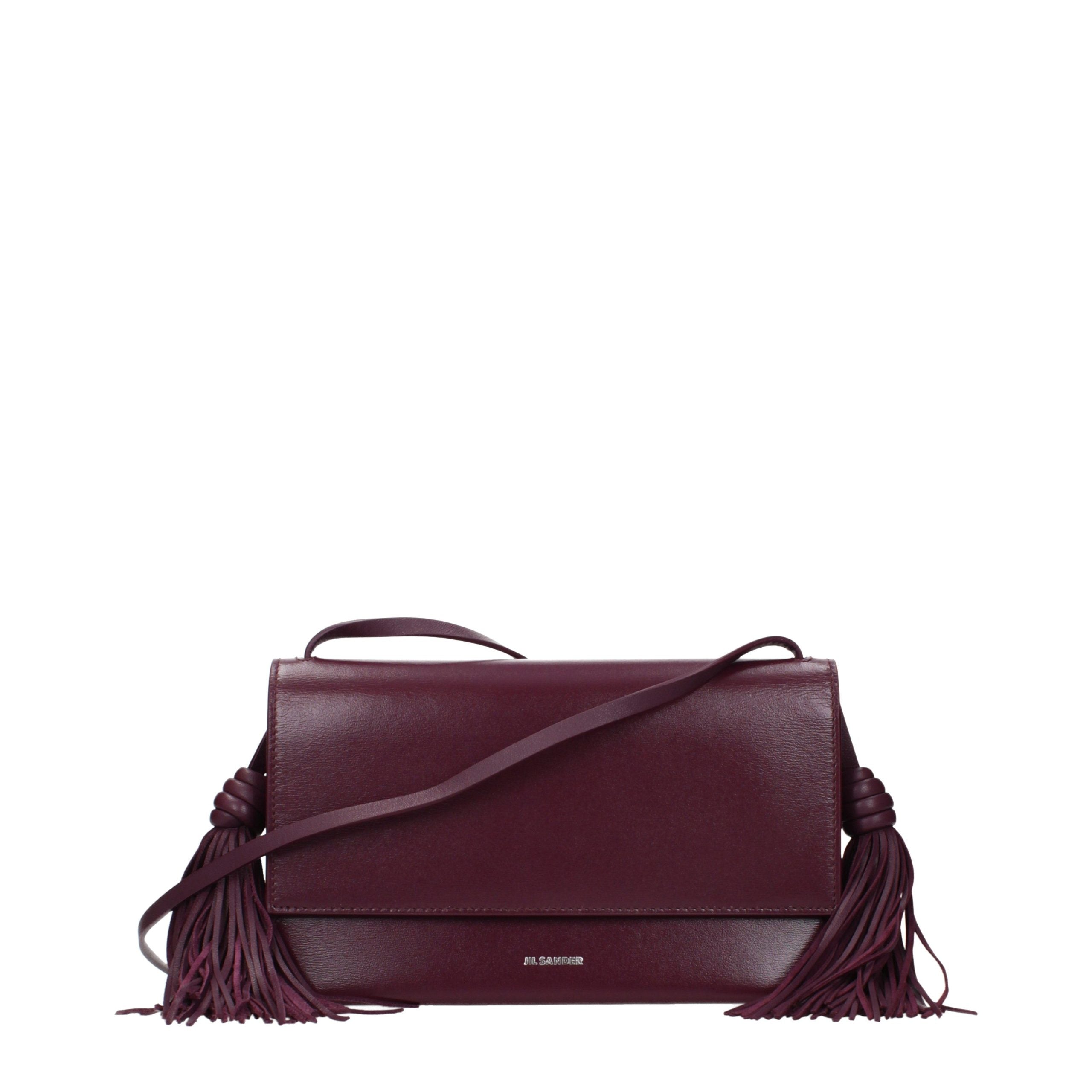 Indulge in the exquisite allure of the Jil Sander Red Leather Crossbody Bag, where luxurious craftsmanship meets timeless elegance, enhancing your sophisticated presence.