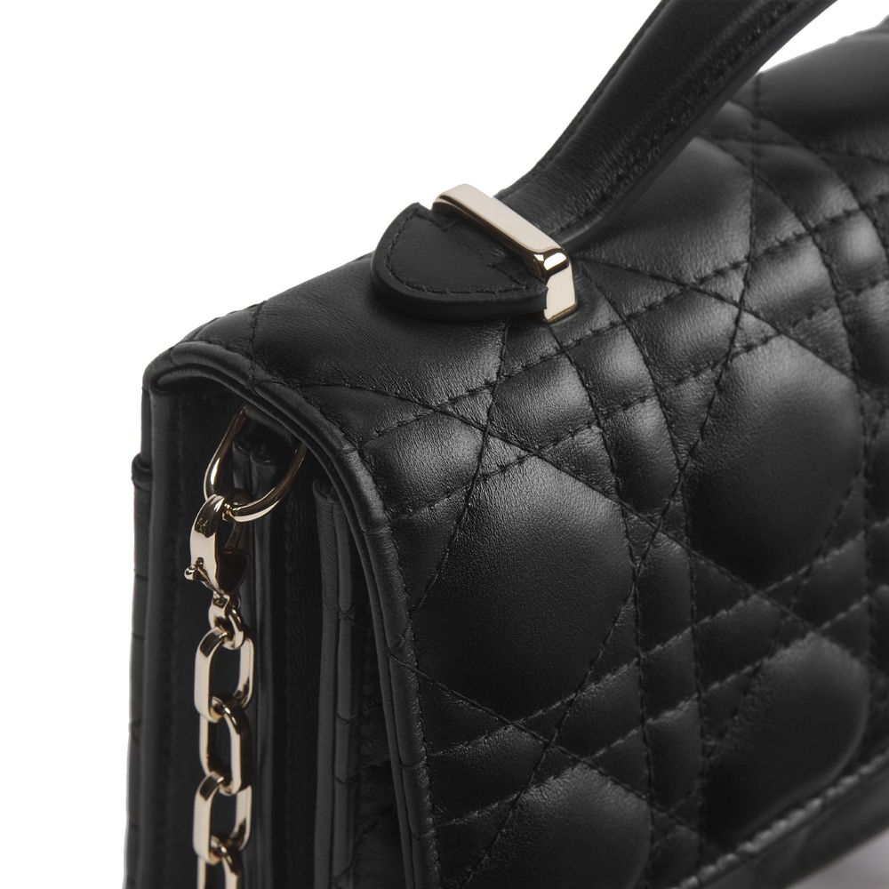 Indulge in the elegance of the Dior Black Leather Shoulder Bag, crafted from exquisite quilted lambskin, embodying timeless luxury and sophistication for the discerning individual.