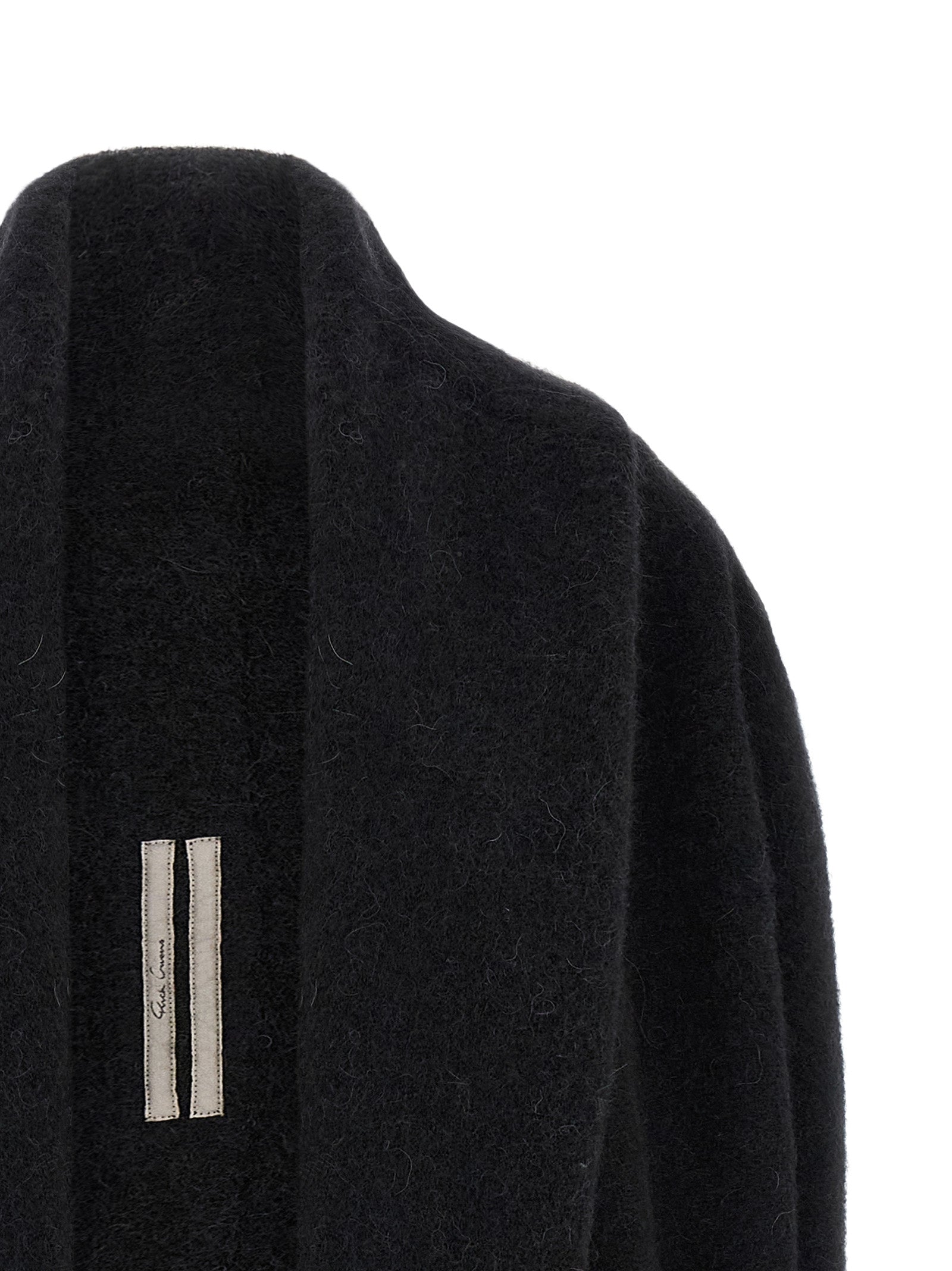 Indulge in the Rick Owens Black Marabou Cardigan, a sculptural knit masterpiece crafted from luxurious alpaca and wool, embodying avant-garde elegance for the discerning style connoisseur.