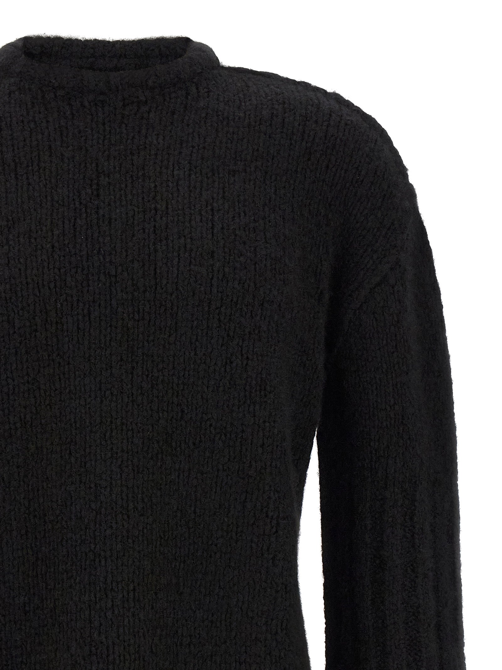 Indulge in the Rick Owens Black Cashmere Cardigan, a luxurious blend of cashmere and silk, embodying bold elegance and timeless sophistication for discerning wardrobes.