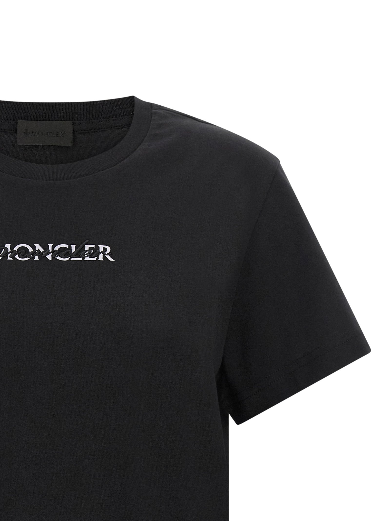 Discover the Moncler Black Cotton T-Shirt, a blend of bold minimalism and luxurious comfort, perfect for those who embody elegance and sophistication.