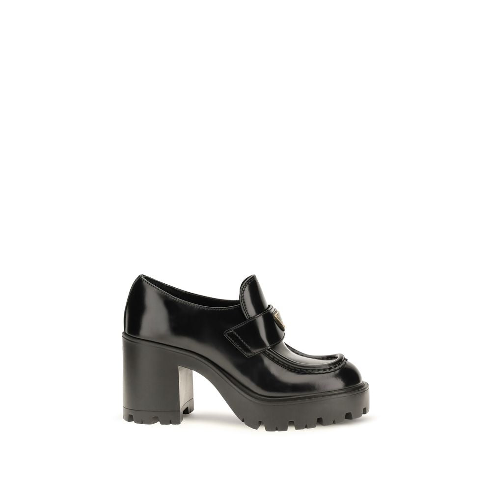Indulge in the exquisite Prada Black Calf Leather Bos Taurus Platform Loafers, where unparalleled craftsmanship meets luxurious design, elevating your style to new heights.