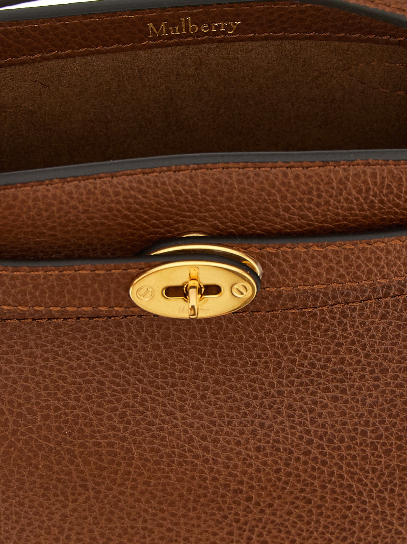 Elevate your style with the Mulberry Islington mini bucket bag, crafted from luxurious hammered calfskin leather, embodying sophistication and timeless elegance.