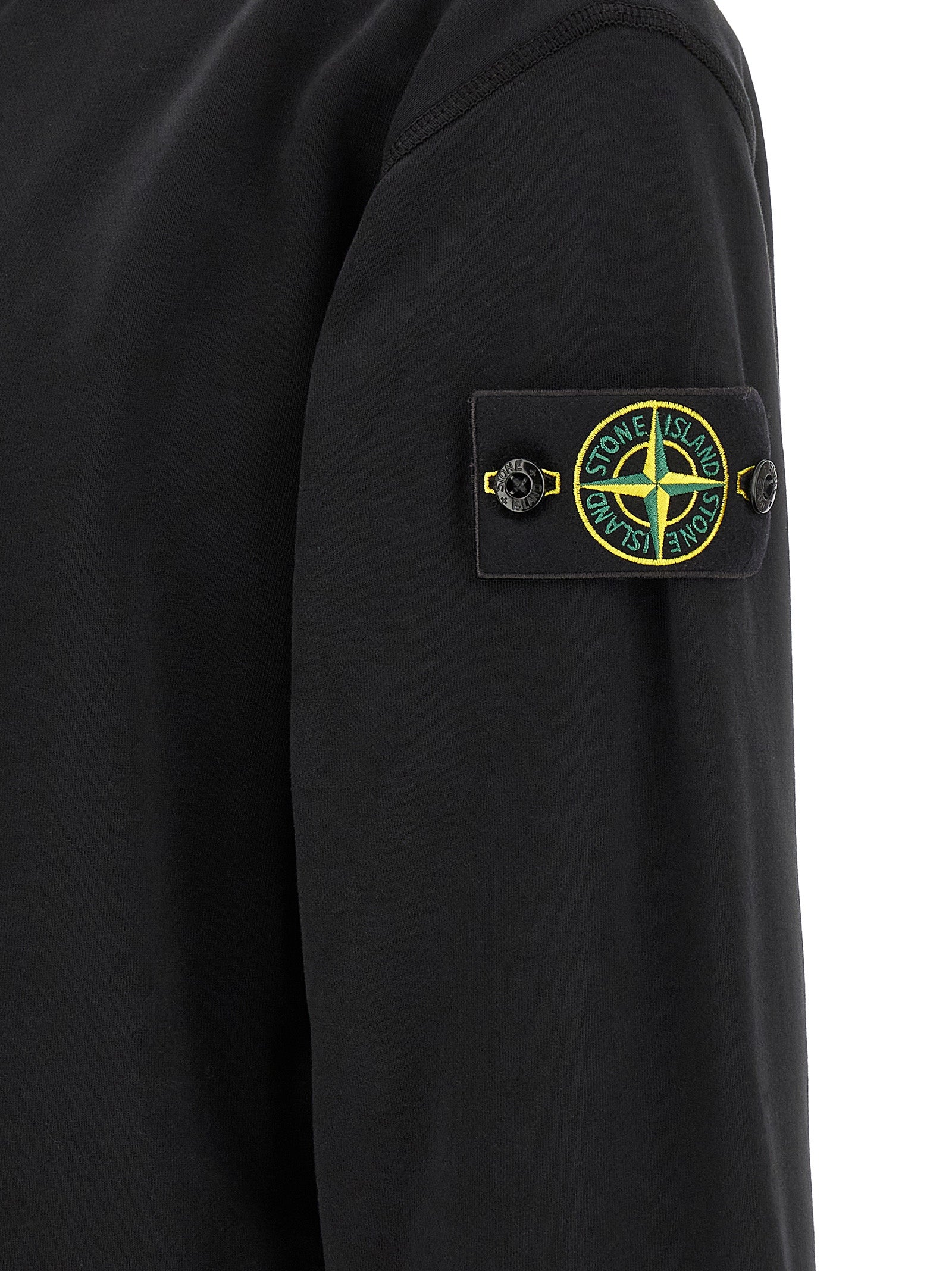 Indulge in the Stone Island Black Cotton Sweatshirt, a fusion of organic cotton and innovative design, embodying luxury and comfort for the discerning individual.