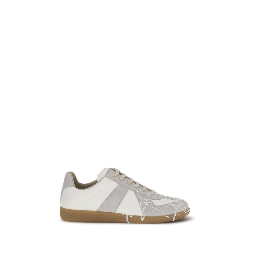 Discover the Maison Margiela Gray Suede Leather Low Top Sneakers, a masterpiece of contemporary design, blending luxurious materials with impeccable craftsmanship for the discerning individual.