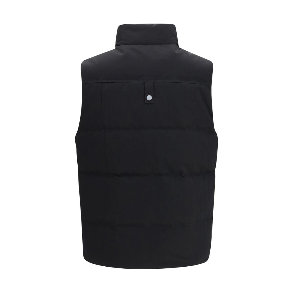 Discover the Moose Knuckles Black Cotton Sleeveless Jacket, a masterful blend of comfort and style, featuring a down-filled collar and exquisite detailing for the discerning individual.