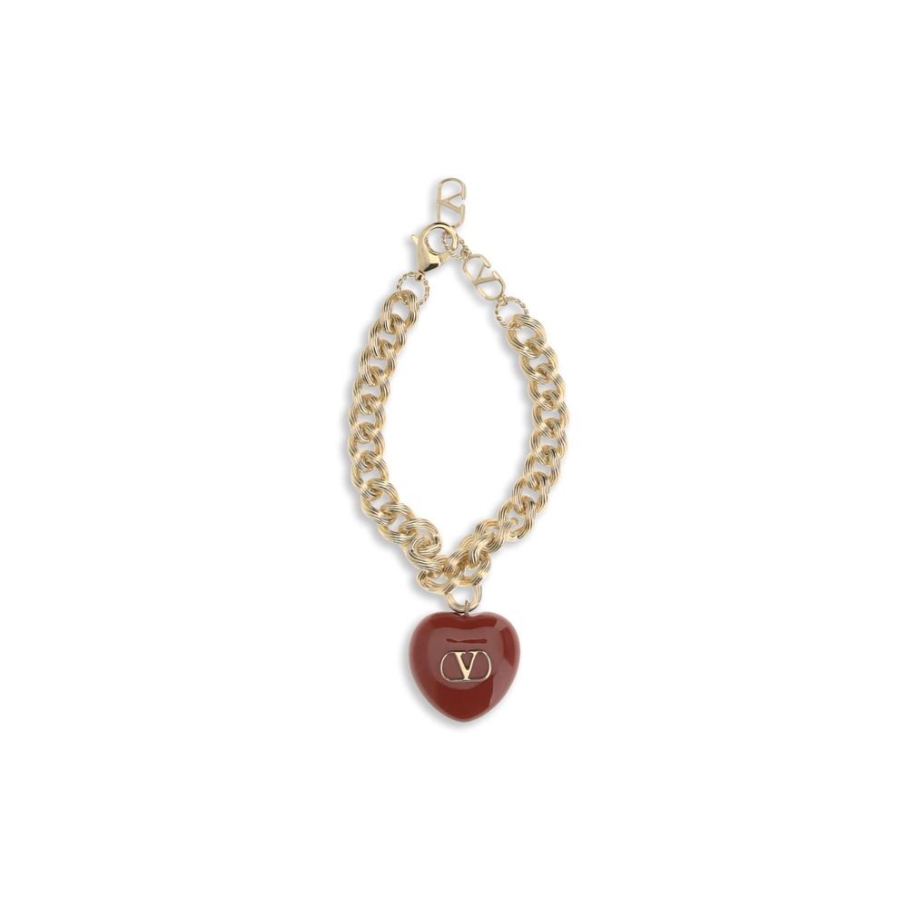 Indulge in the exquisite Coeur Royal chain Bracelet by Valentino Garavani, a gold-plated masterpiece adorned with a black heart charm, embodying refined romance and elegance.