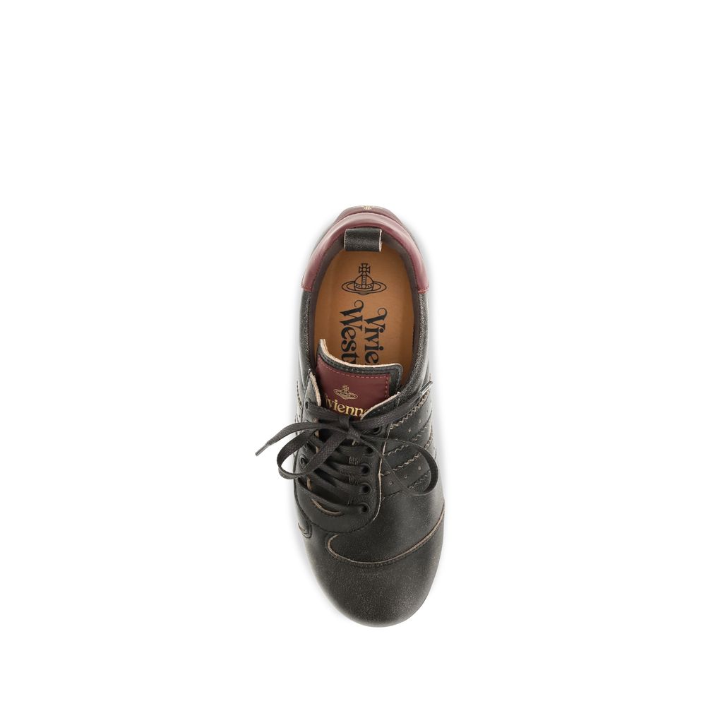 Elevate your style with Vivienne Westwood's Black Calf Leather Bos Taurus Sneakers, a masterpiece of distressed leather and iconic design, perfect for the discerning individual.