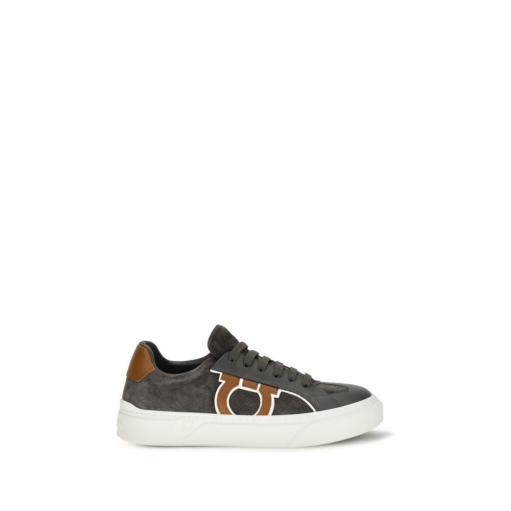 Elevate your style with Ferragamo's Gancini Sneakers, crafted from sumptuous gray suede leather, embodying Italian craftsmanship and contemporary elegance for the discerning individual.