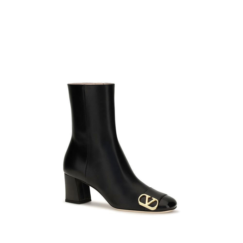 Indulge in the exquisite craftsmanship of Valentino Garavani's Black Calf Leather Bos Taurus Ankle Boots, where polished elegance meets architectural design for an unmatched luxury experience.