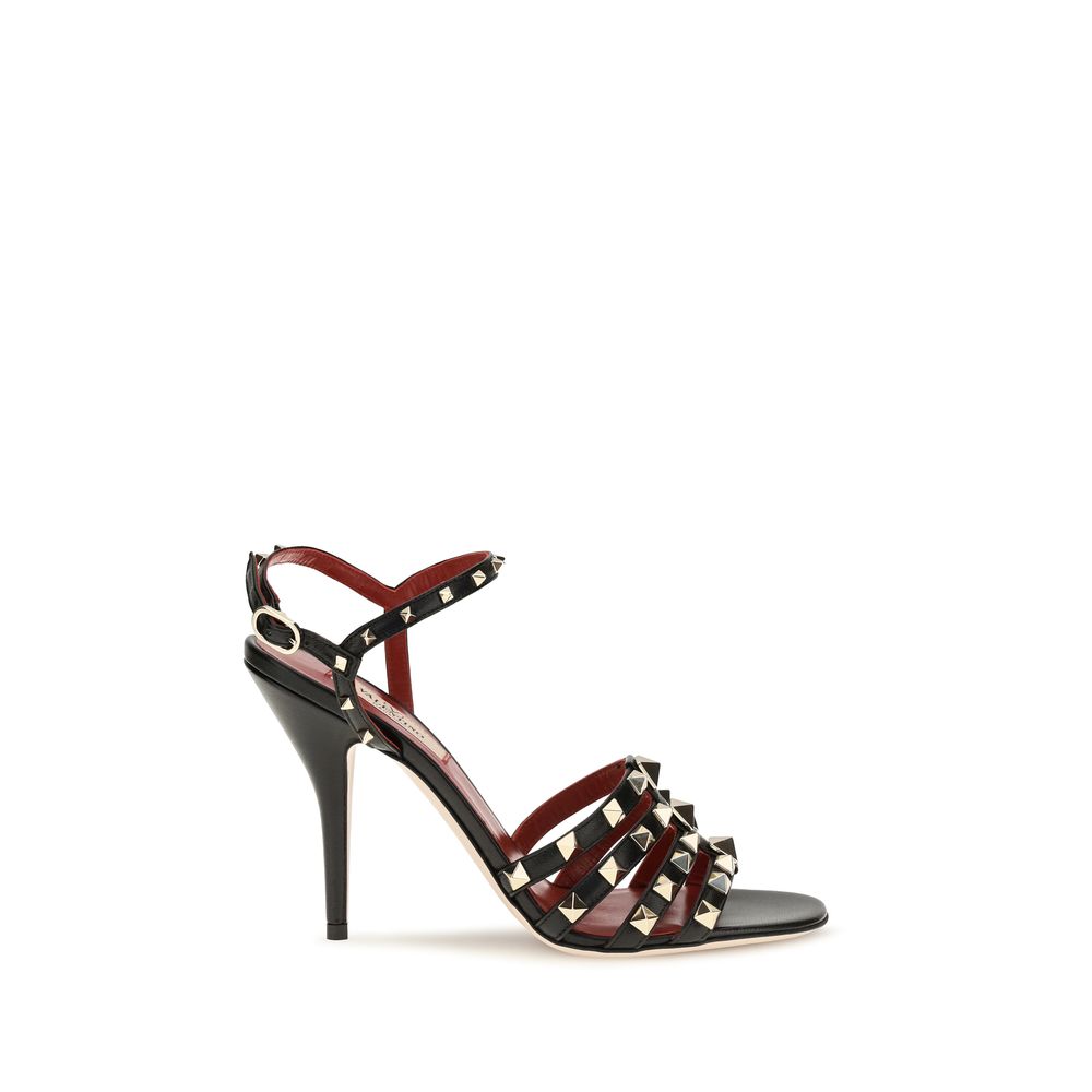 Indulge in the exquisite elegance of Valentino Garavani Black Goatskin Stiletto Heel Sandals, where iconic design meets luxurious craftsmanship, elevating every silhouette.