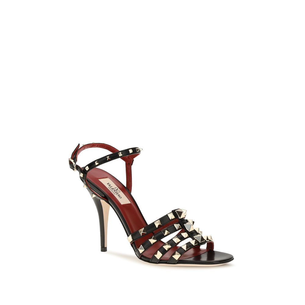 Indulge in the exquisite elegance of Valentino Garavani's Black Goatskin Stiletto Heel Sandals, where iconic design meets luxurious craftsmanship for a refined silhouette.