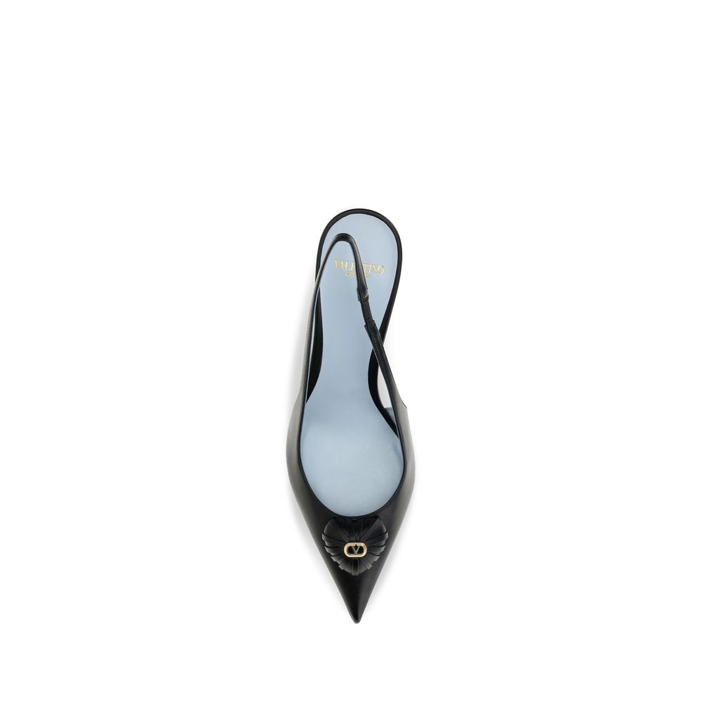 Experience the exquisite allure of Valentino Garavani's Coeur Royal Slingback Pumps, crafted from luxurious kidskin leather, embodying timeless elegance and romantic charm.