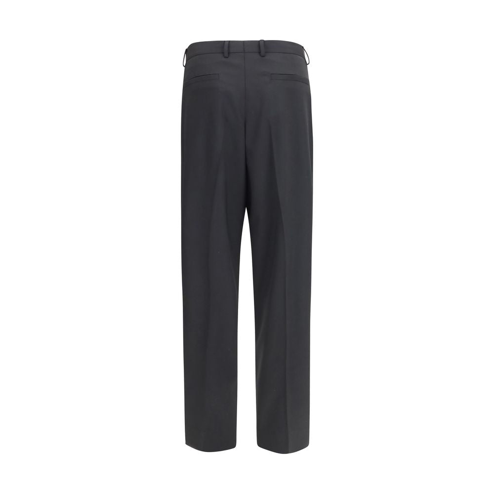 Elevate your wardrobe with Dolce & Gabbana's Black Wool Oves Aries Dress Pants, a timeless blend of luxury and sophistication, crafted for the discerning individual.