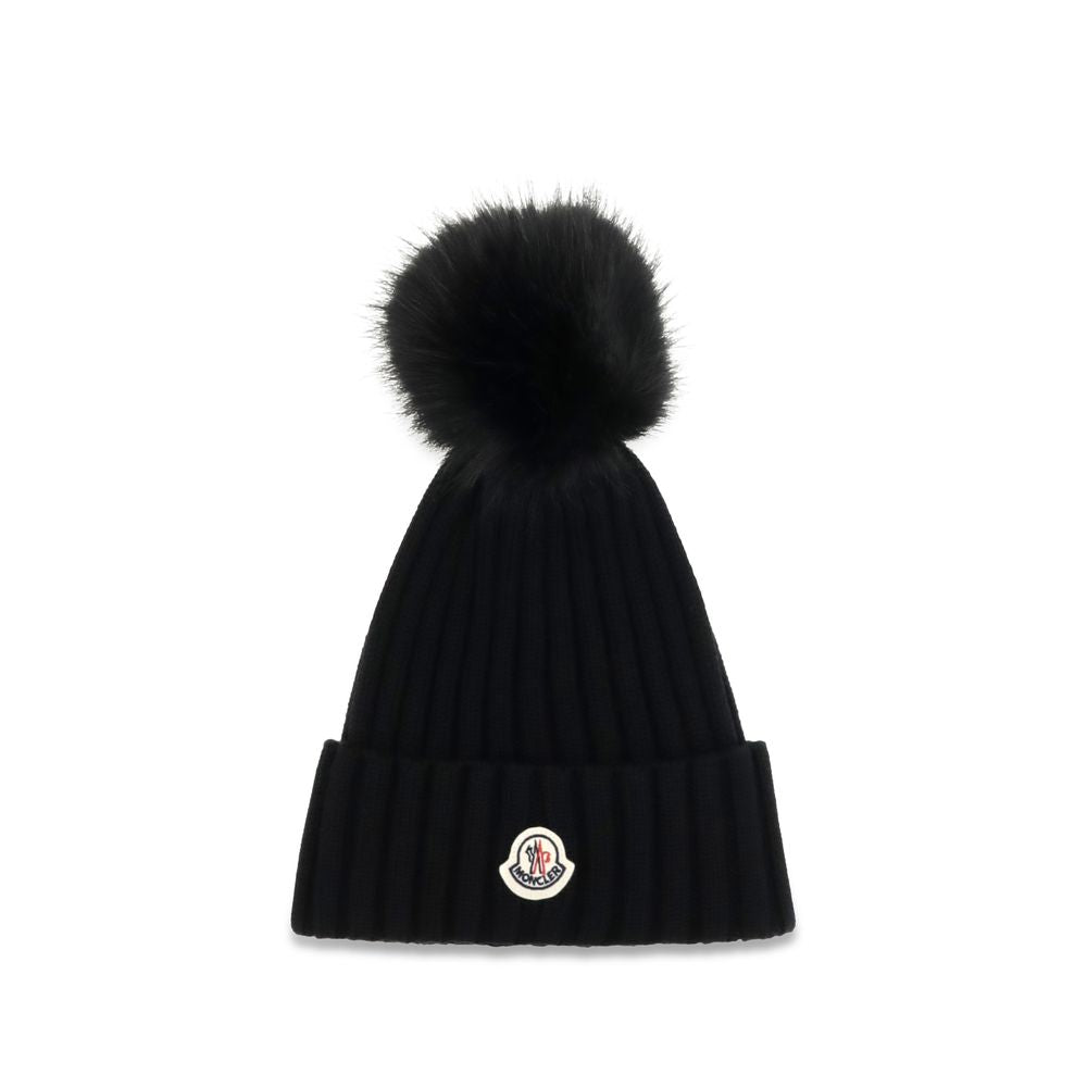 Indulge in the Moncler Black Wool Oves Aries Beanie, a masterpiece of virgin wool and refined design, perfect for those who embrace elegance and warmth in every season.