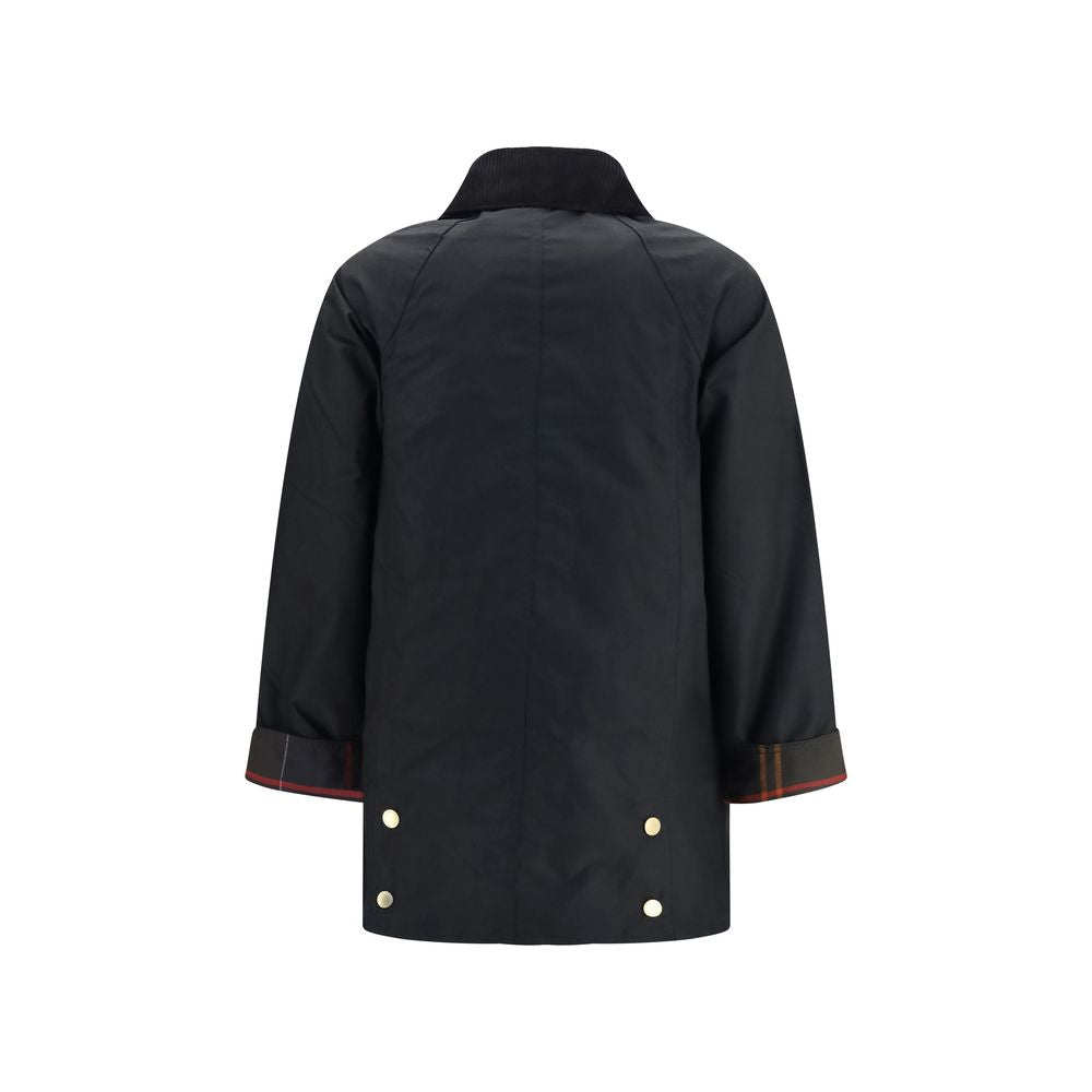 Indulge in the Barbour Black Cotton Full-Length Jacket, a masterpiece of heritage craftsmanship, blending timeless elegance with modern femininity for the discerning connoisseur.