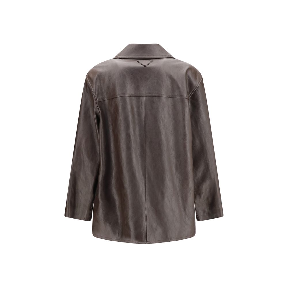 Indulge in the exquisite Prada Brown Lamb Leather Jacket, a masterpiece of tailored elegance, perfect for those who appreciate unparalleled craftsmanship and timeless luxury.