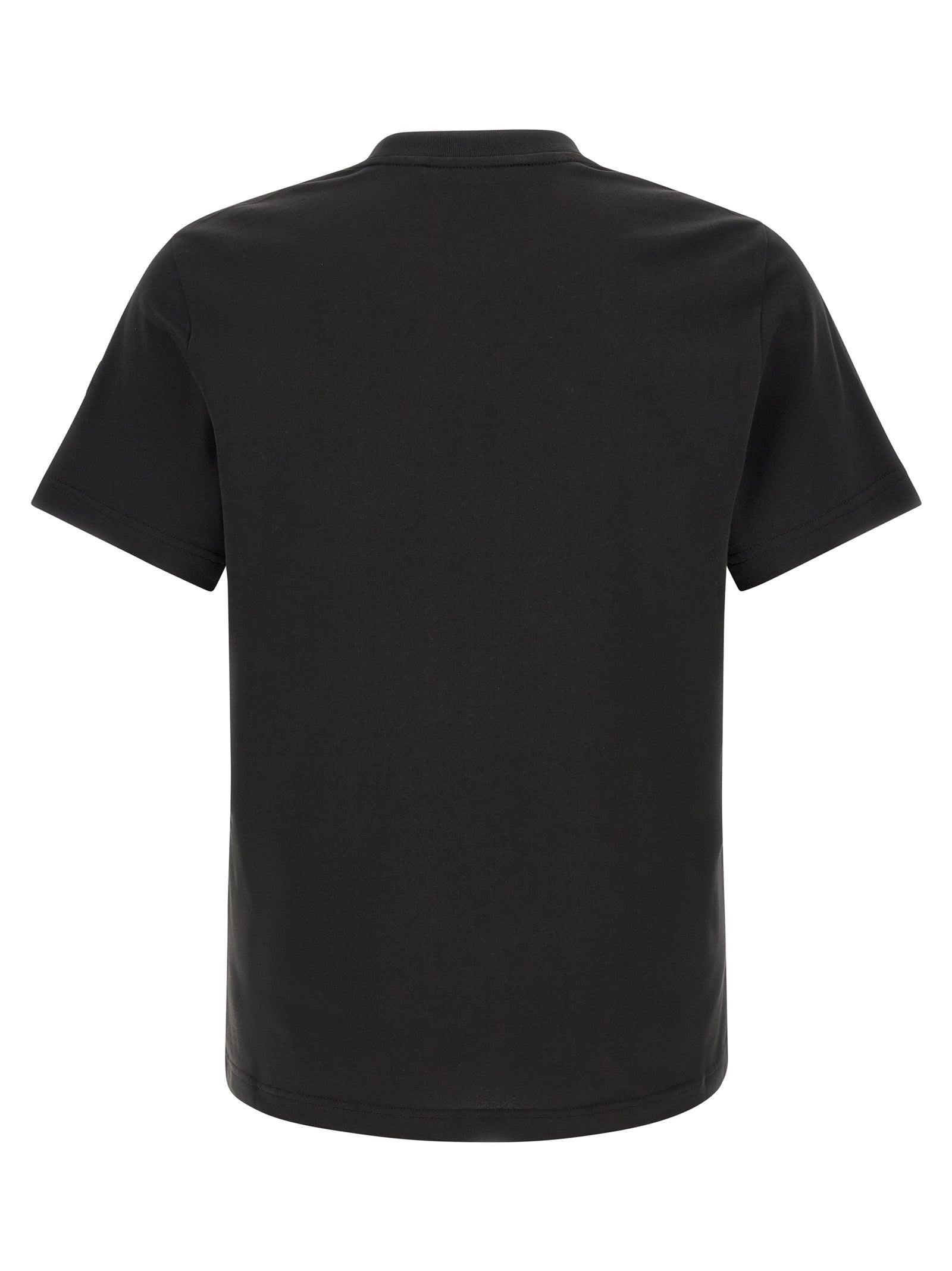 Discover the Moncler Black Cotton T-Shirt, a masterpiece of casual luxury, featuring iconic details and impeccable craftsmanship that elevate your everyday elegance.
