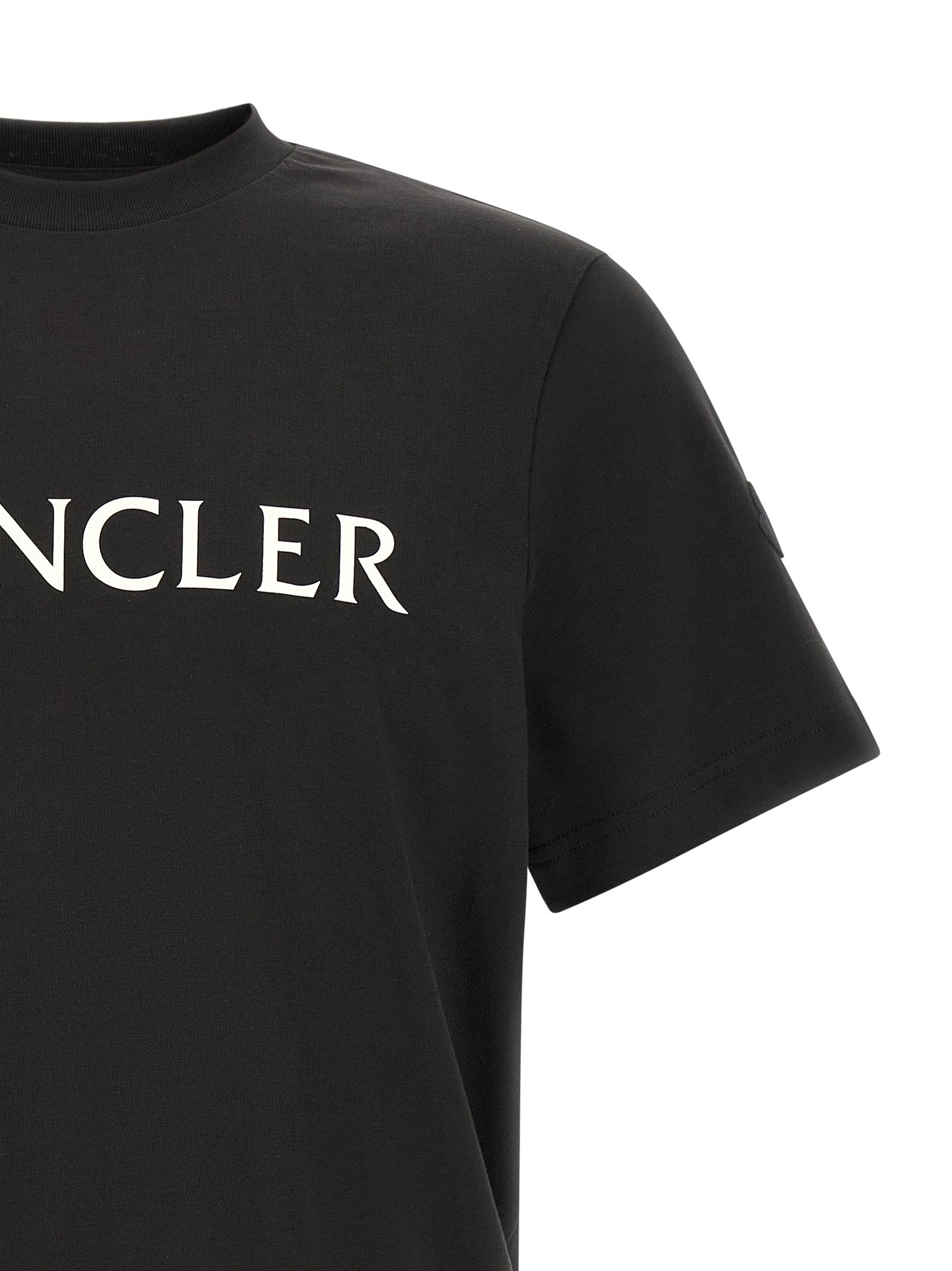 Experience the allure of Moncler's Black Cotton T-Shirt, a masterpiece of casual luxury, blending iconic design with unparalleled comfort for the discerning individual.