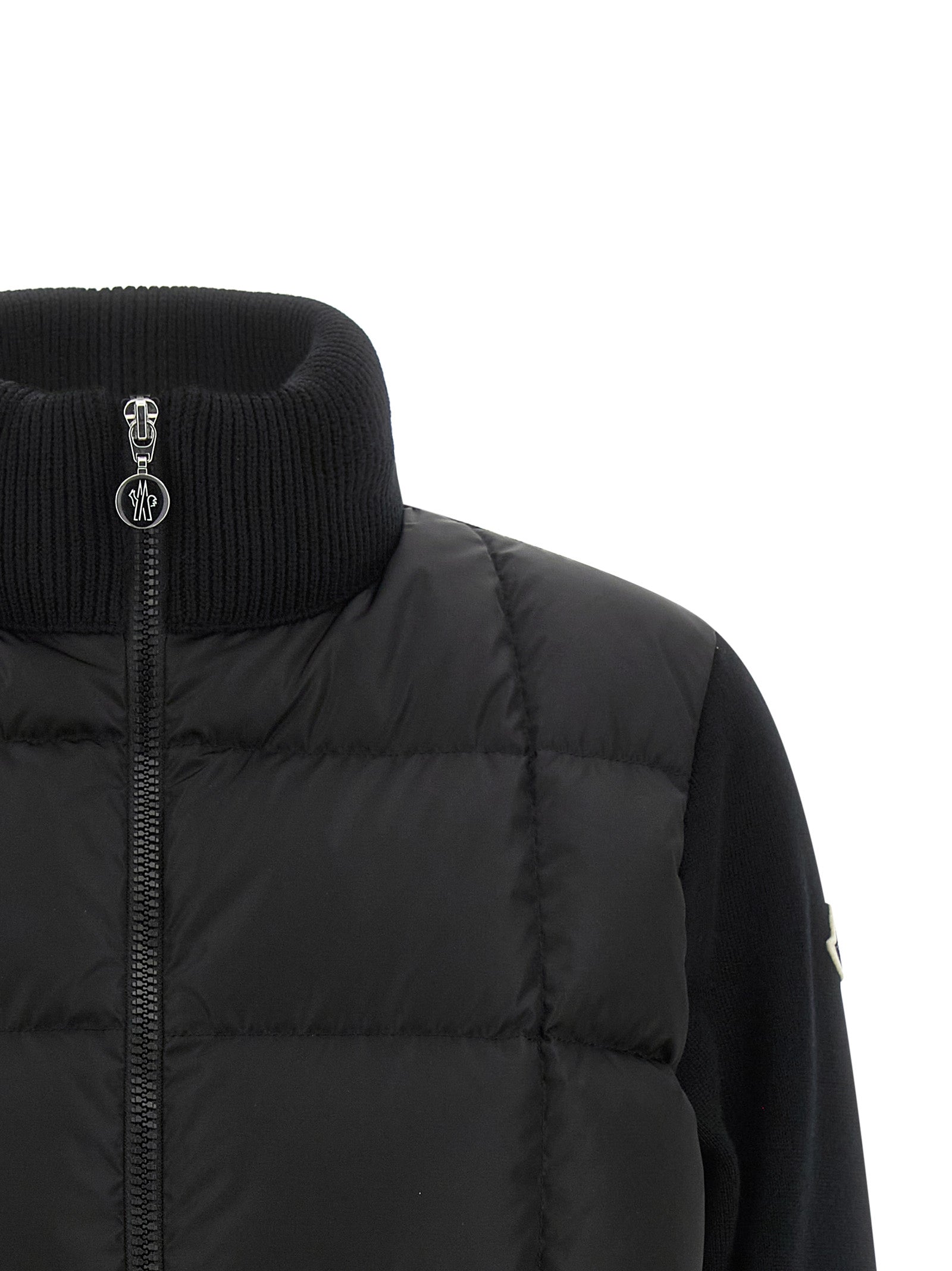 Indulge in the Moncler Black Virgin Wool Cardigan, a masterpiece of luxurious merino wool and innovative design, exuding timeless elegance and unparalleled warmth.