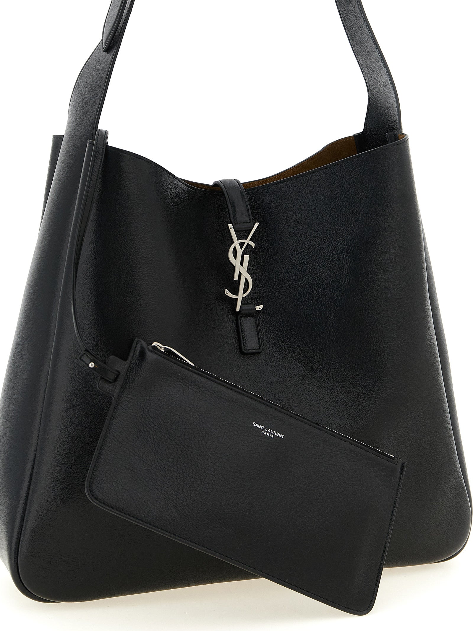 Indulge in the allure of the Saint Laurent Le 5 à 7 Gobo shoulder bag, crafted from exquisite black calfskin, a timeless piece that elevates any ensemble with luxurious sophistication.