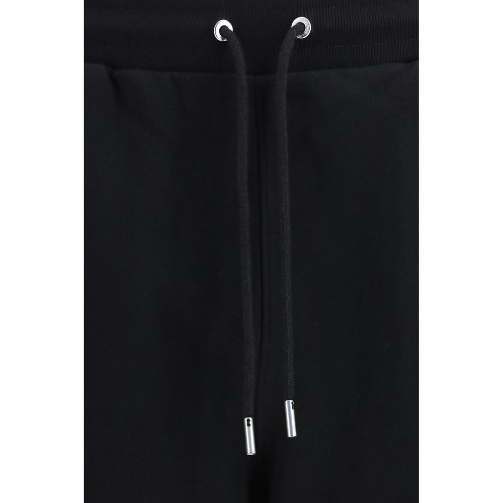 Indulge in the refined elegance of Ami Paris Black Cotton Joggers, crafted from soft cotton for a luxurious fit that elevates your everyday style with effortless sophistication.