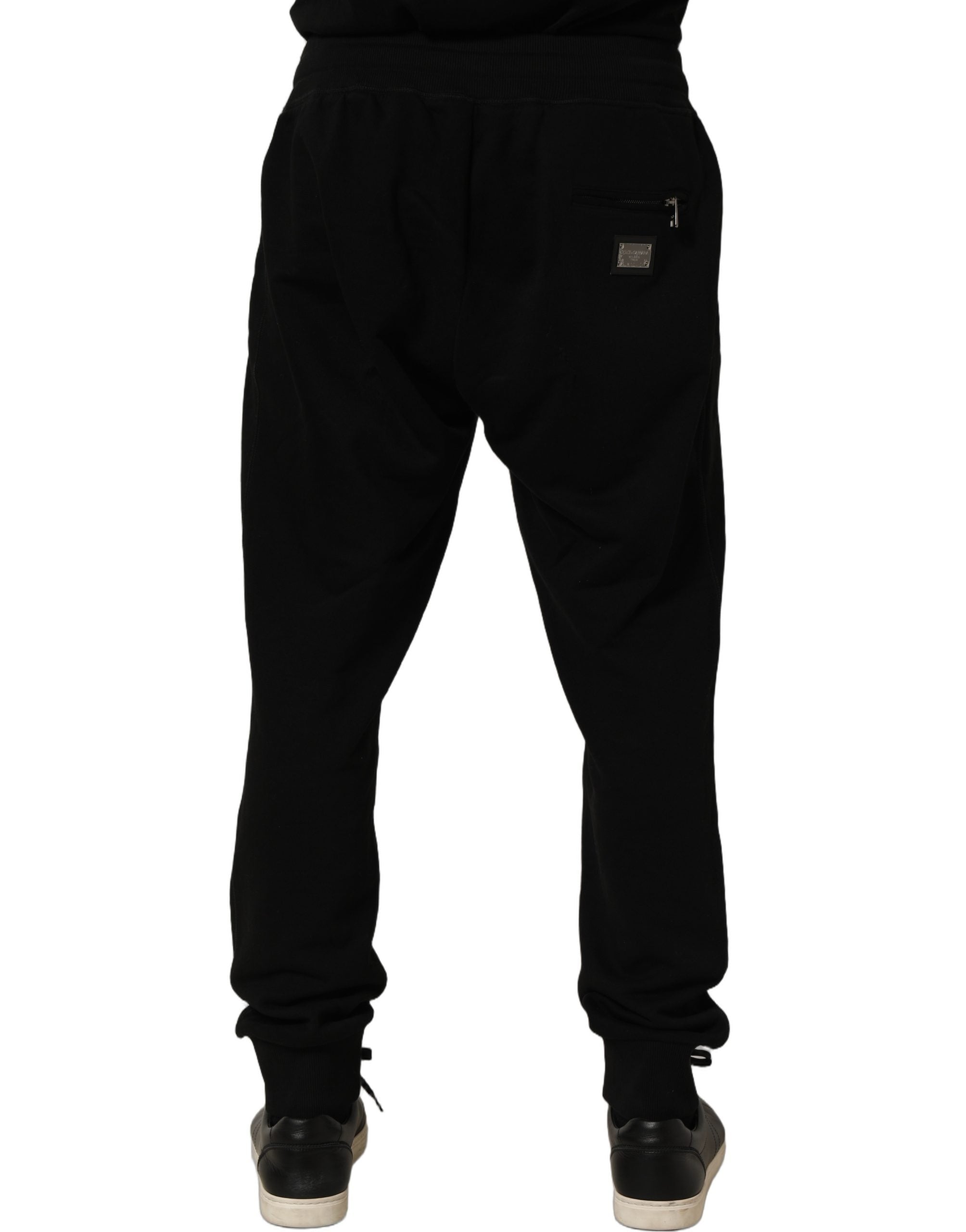 Indulge in the exquisite allure of Dolce & Gabbana's Black Cotton Logo Jogger Sweatpants, where luxurious craftsmanship meets timeless elegance for the discerning individual.