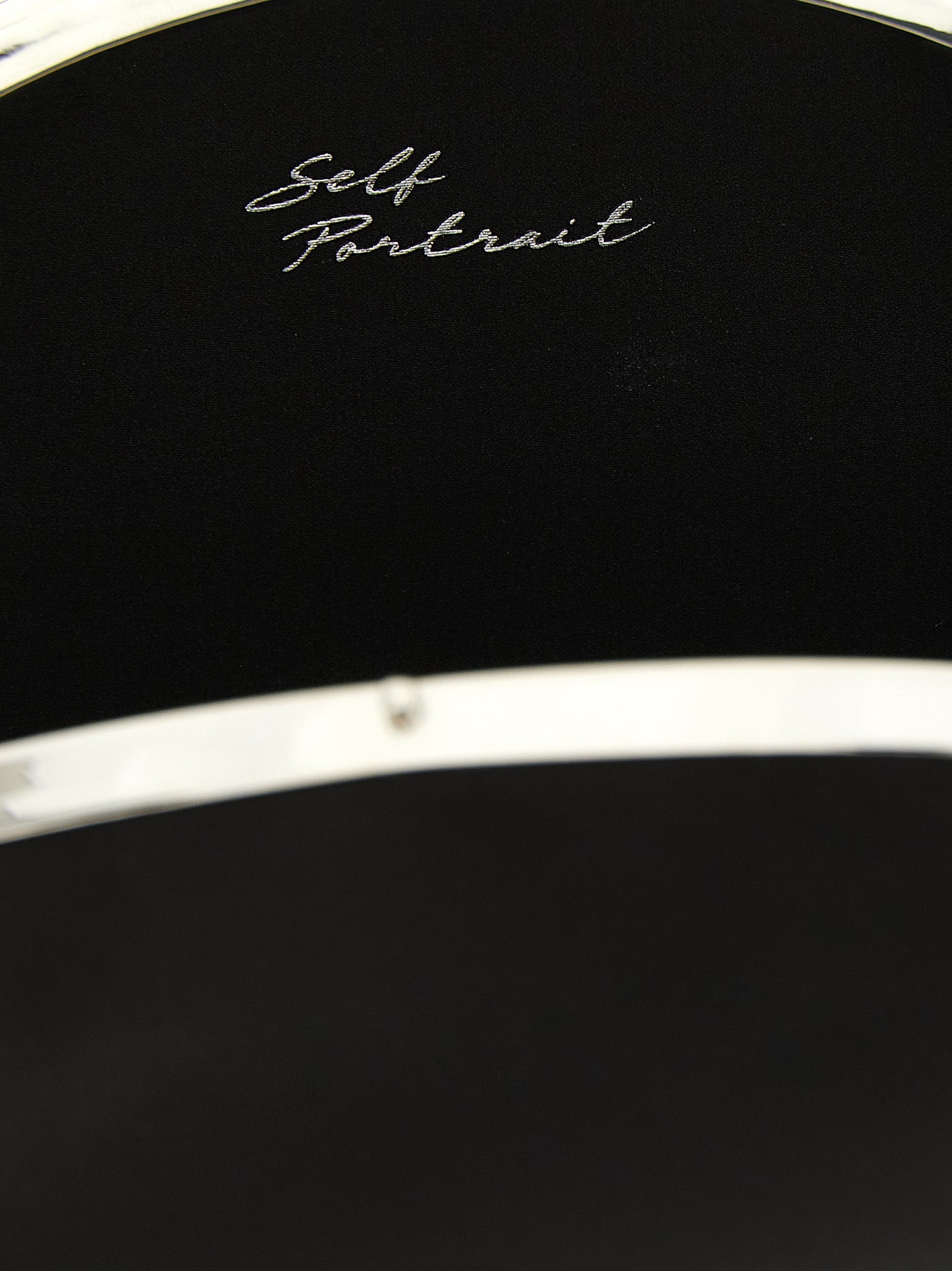 Elevate your evening allure with the Self-Portrait Black Satin Oval Clutch, a masterpiece of structured elegance and refined glamour, perfect for any sophisticated occasion.
