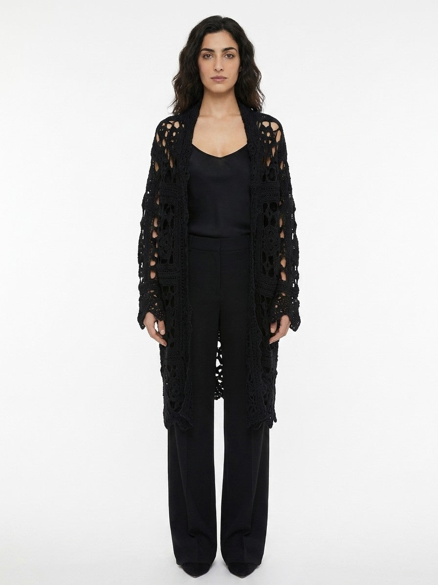 Indulge in the elegance of the Dolce & Gabbana Black Virgin Wool Cardigan, a masterpiece of Italian craftsmanship that elevates your wardrobe with luxurious warmth and timeless sophistication.